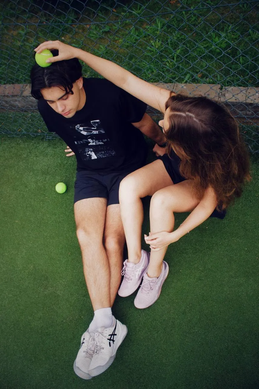 Woman on a Tennis Court Playing with a Mans Head Wallpaper