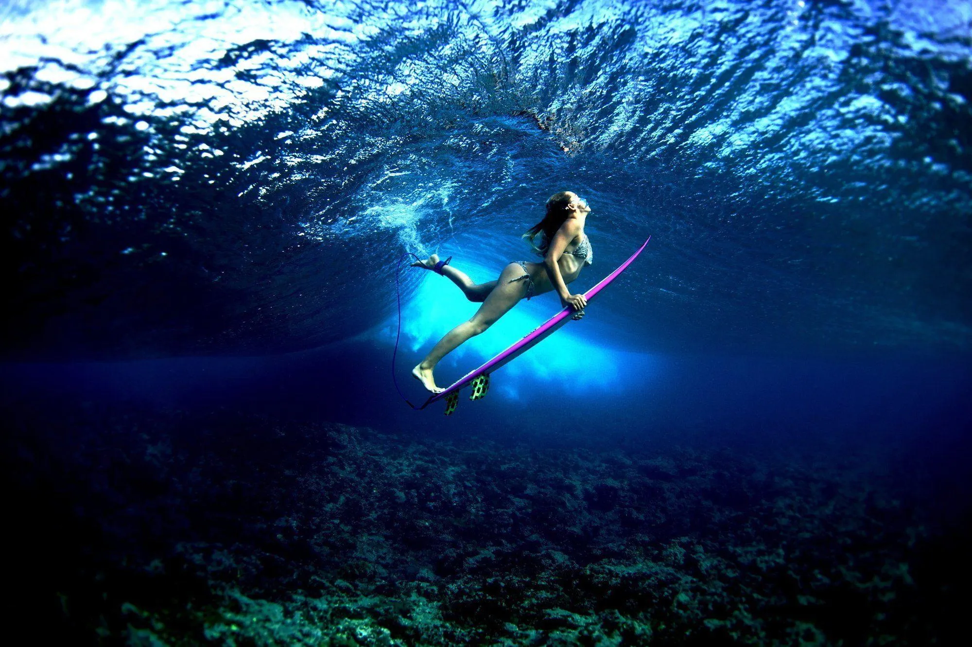 Woman Paddleboarding Underwater in a Deep Clear Ocean