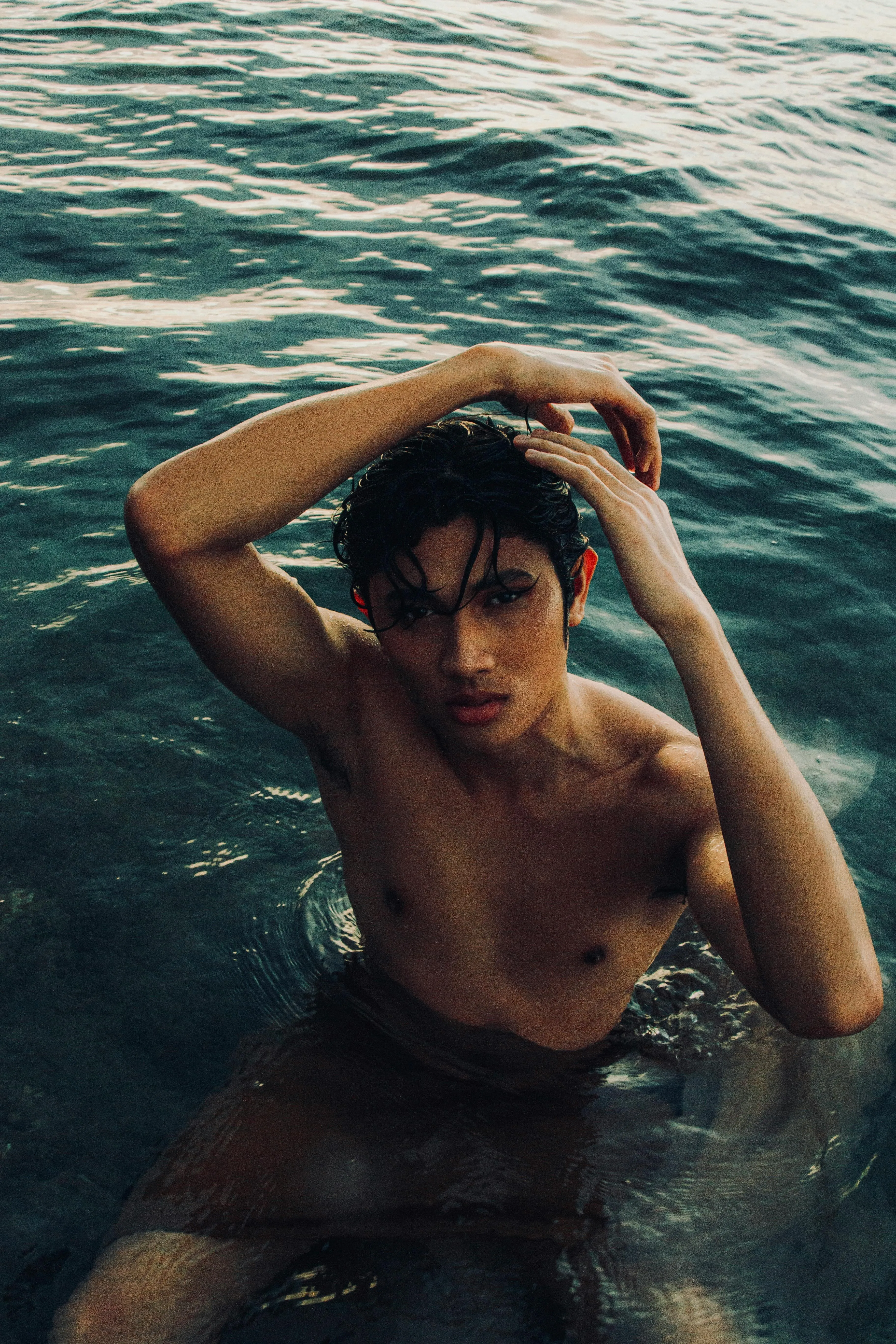 Woman Partially Submerged in Water Posing at Sunset Image