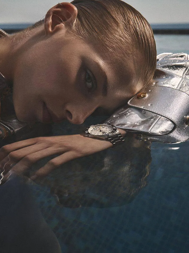 Woman Resting by the Pool with Her Hand Touching the Water