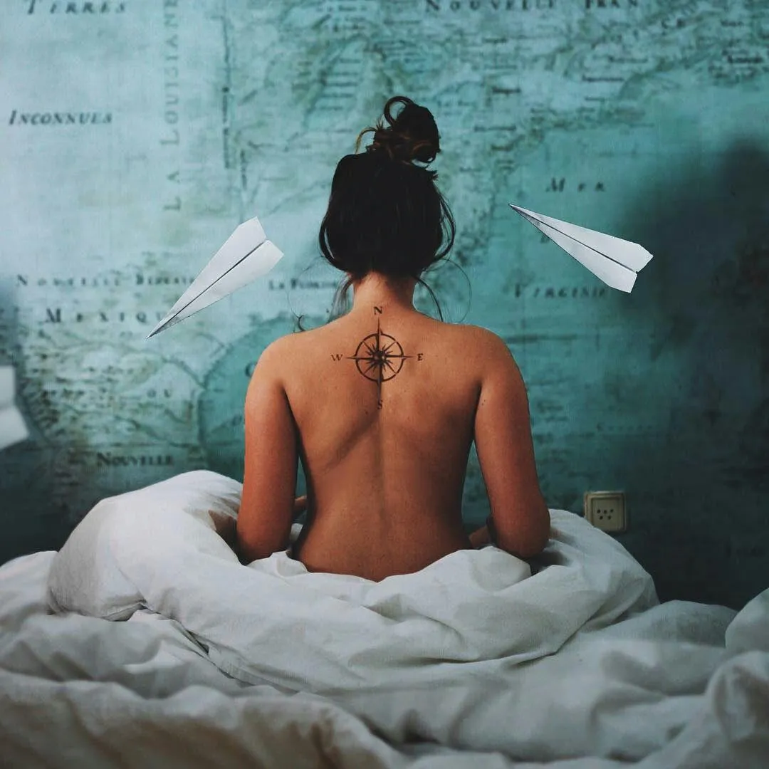 Woman Sitting on Bed with Artistic Paper Airplanes in Frame