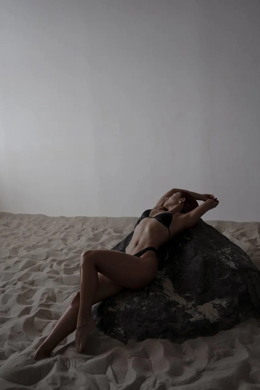 Woman sitting on the floor draped in soft white fabric image