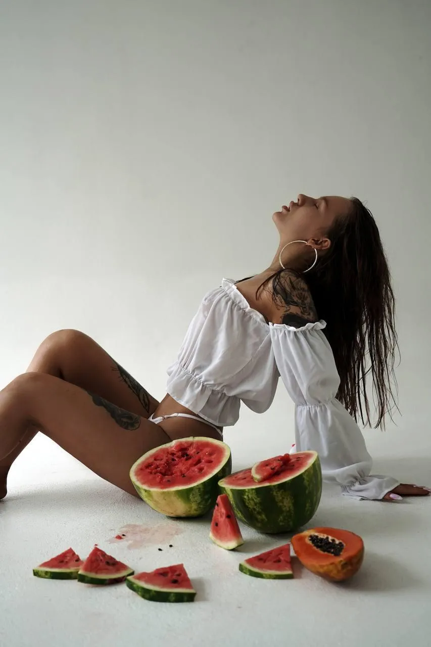 Woman sitting with watermelon slices in a fresh summer vibe