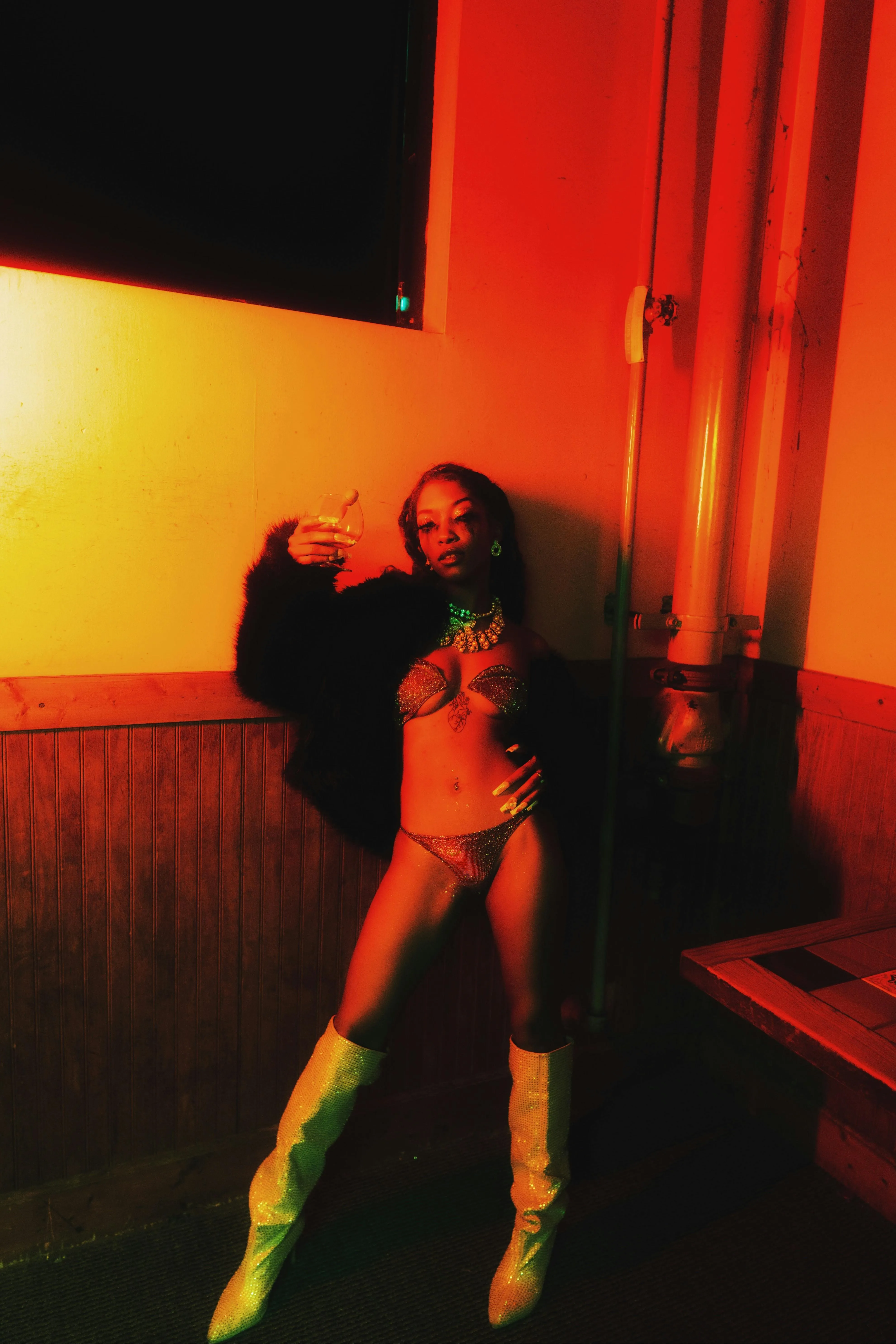 Woman Standing in a Glowing Red Light in a Moody Room Image