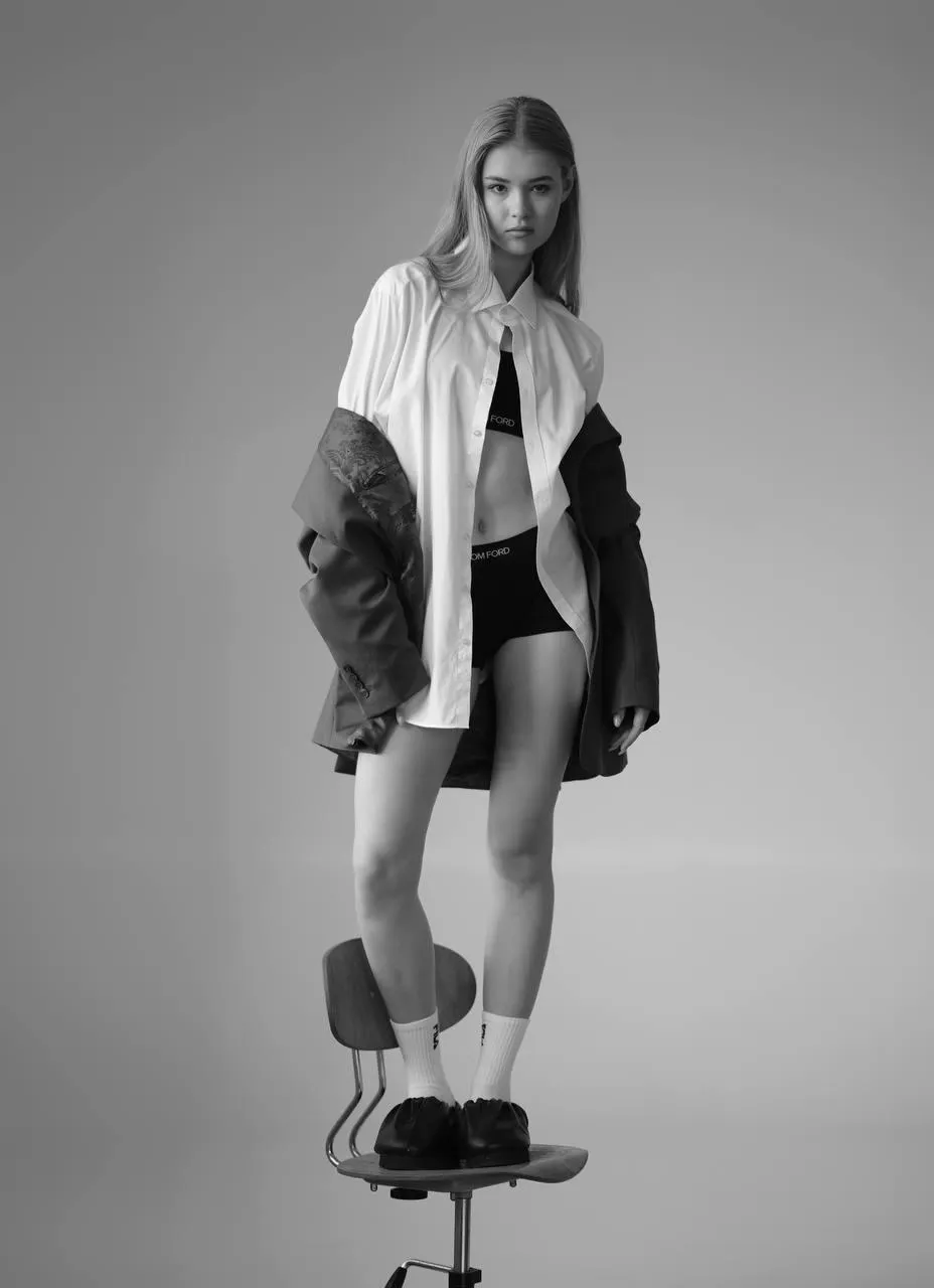 Woman standing in the office chair with a stunning pose