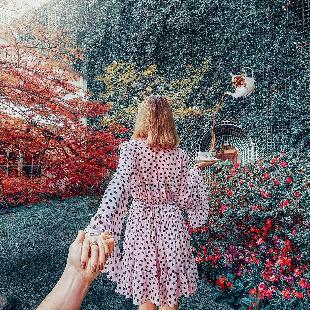 Woman Walking Through a Colorful Garden with Flowers Image