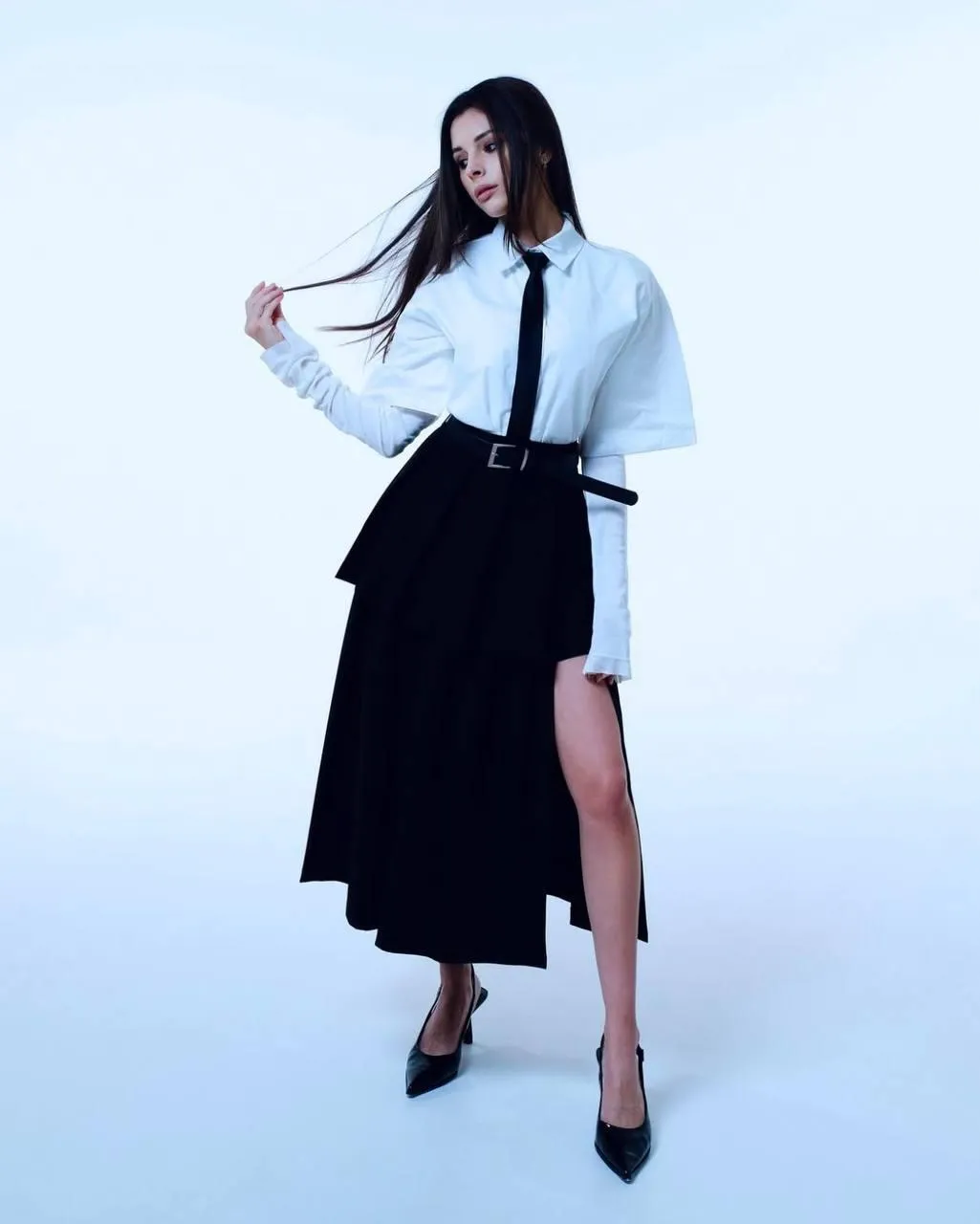 Woman wearing a white full sleeve shirt and a black gown