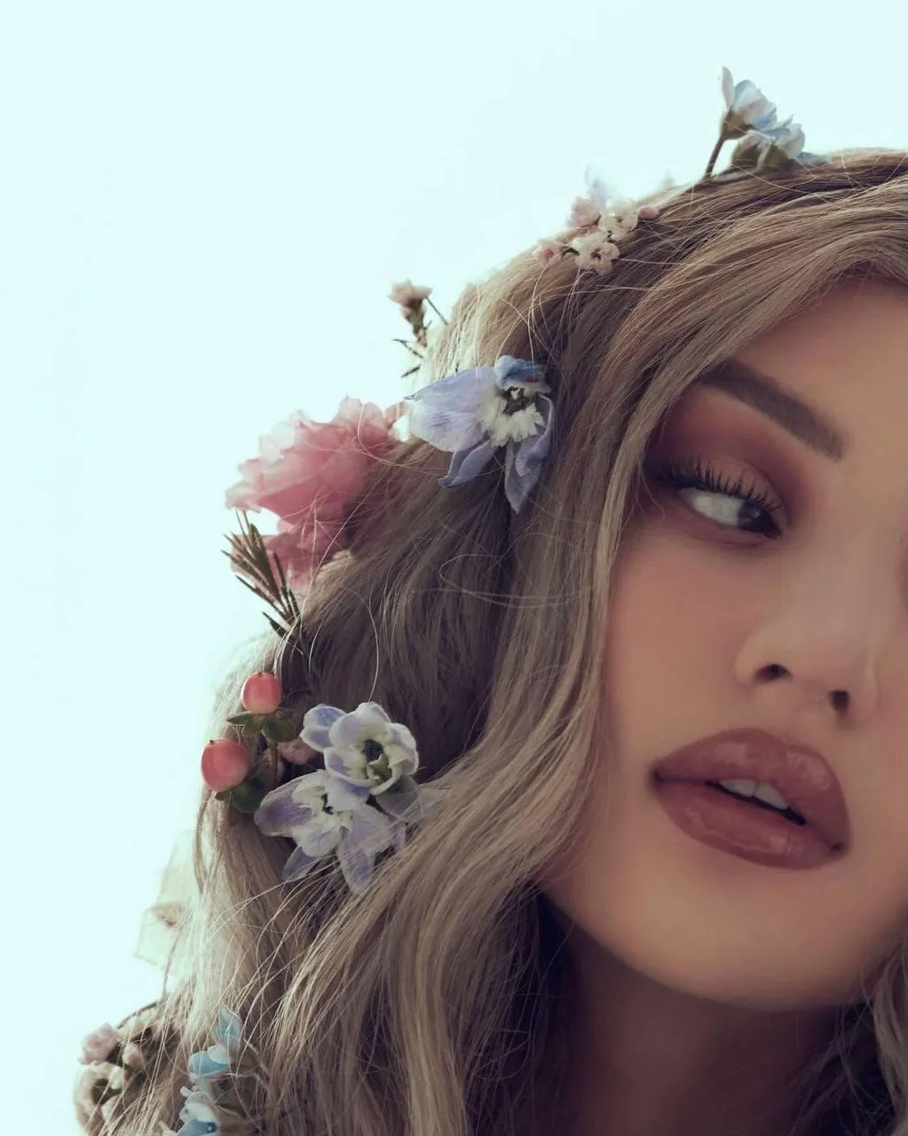 Woman with a Floral Crown And Makeup Looks Dreamily Image