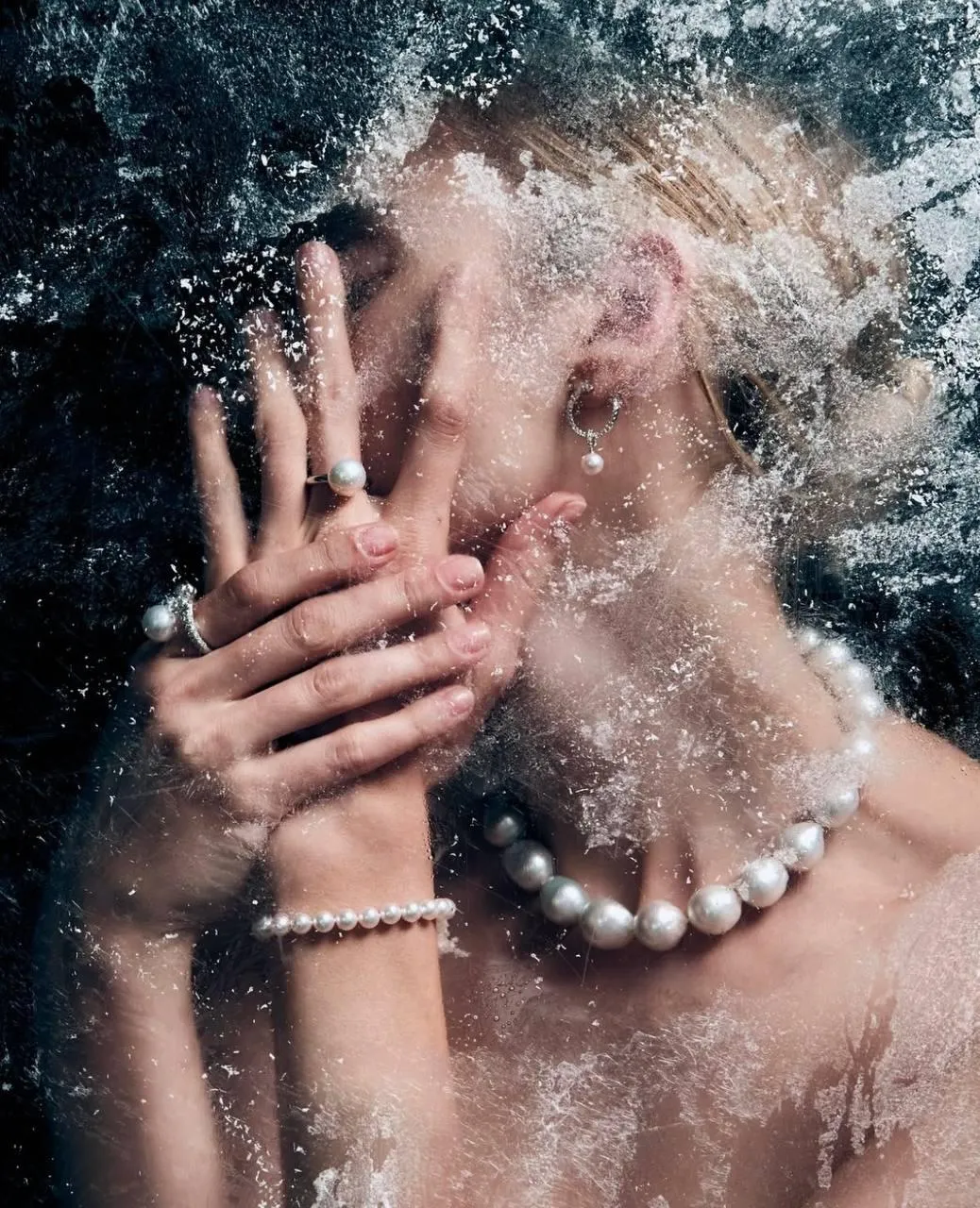 Woman with Hand Covering Face And Water Splashing Wallpaper