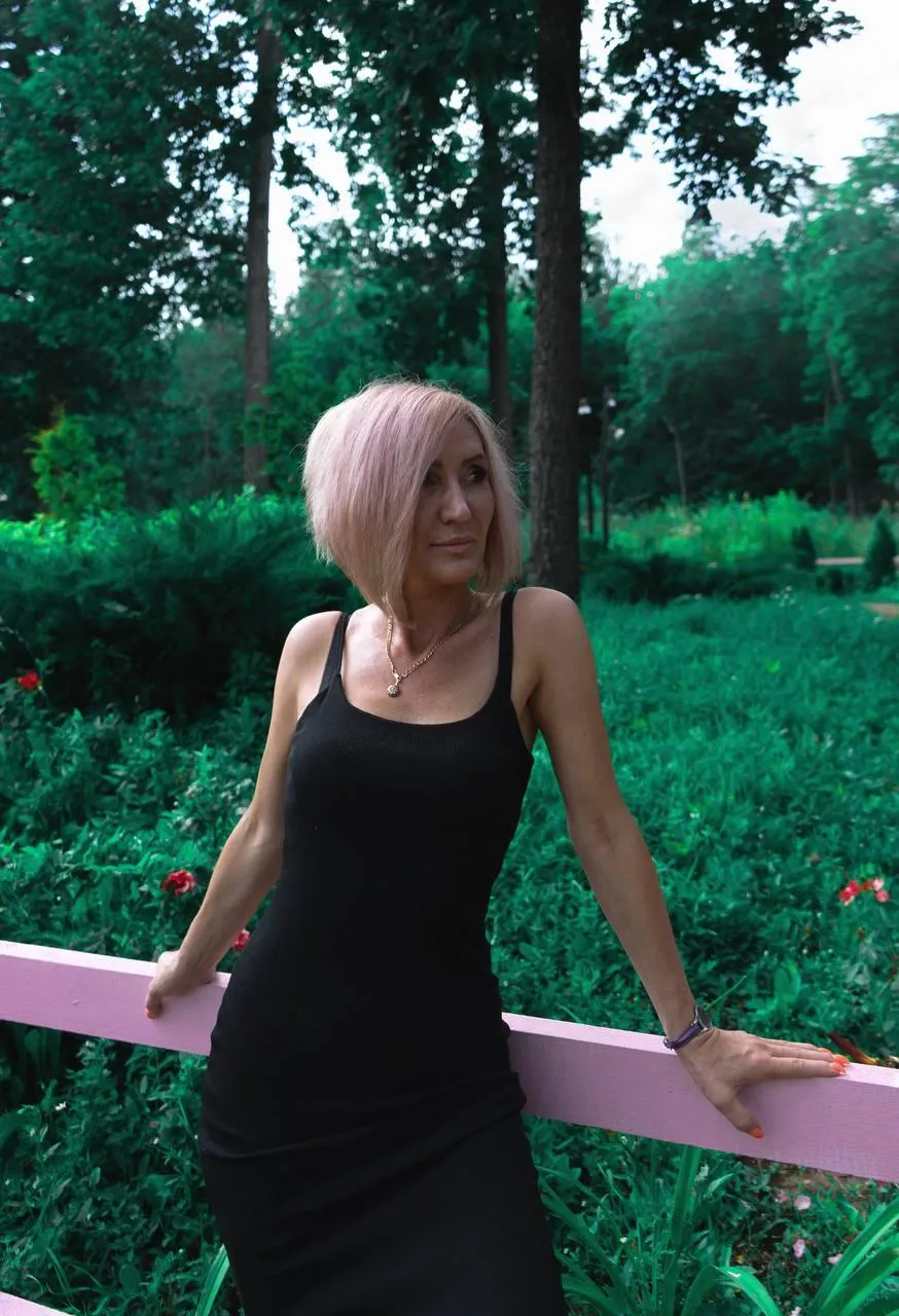 Woman with Pink Hair Standing Near Forest Fence Wallpaper