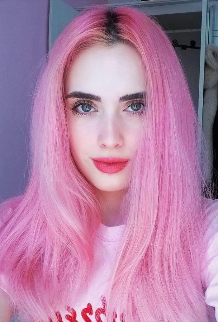 Woman with Vibrant Pink Hair Takes a Selfie with Soft Light