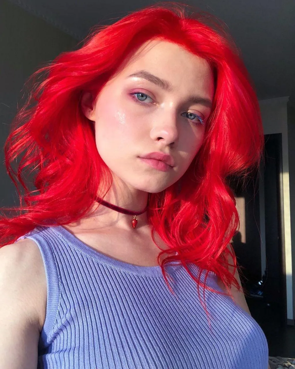 Woman with Vibrant Red Hair Poses in Soft Natural Lighting