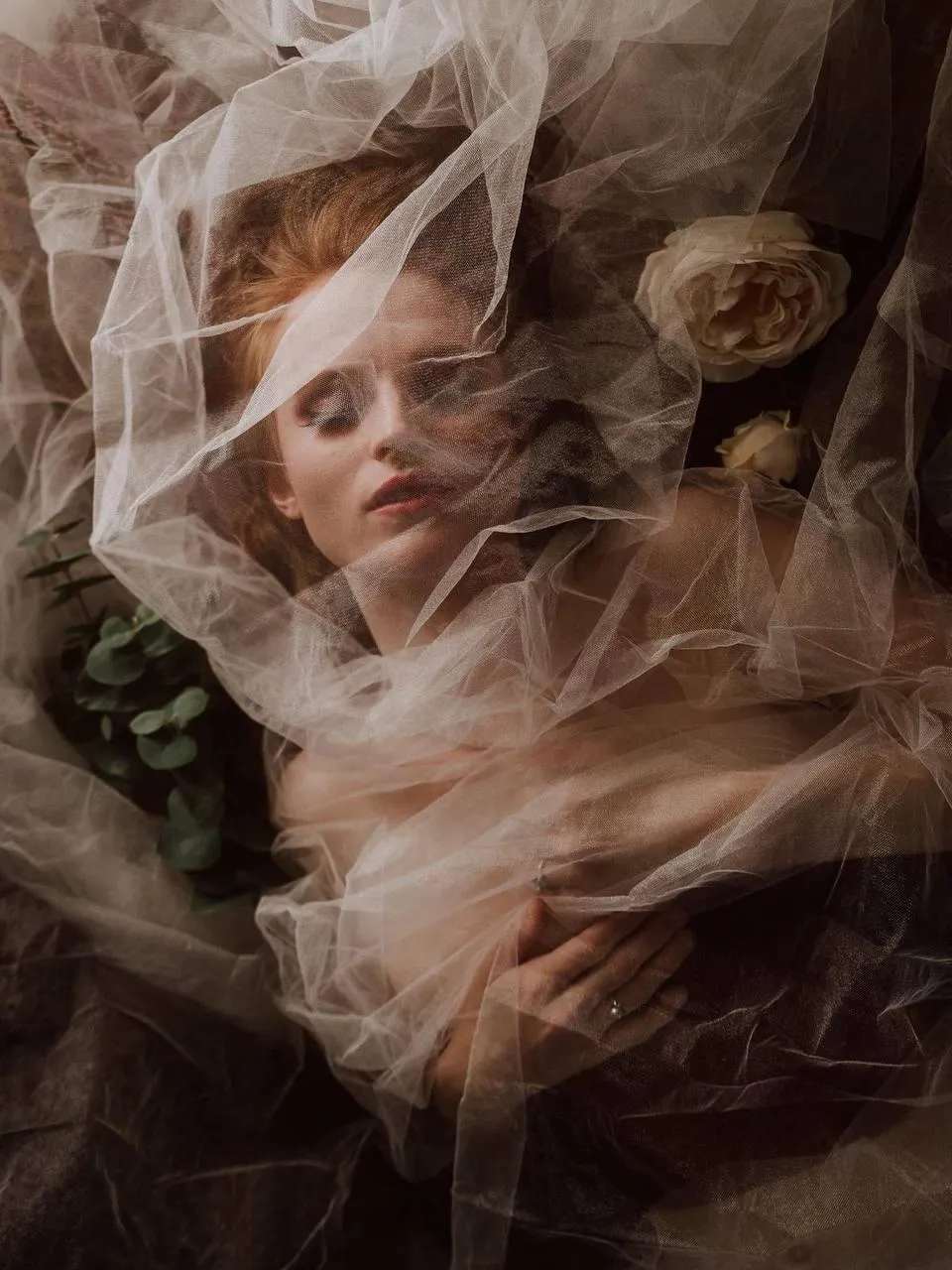 Woman Wrapped in a Fabric Surrounded by Flowers And Lace