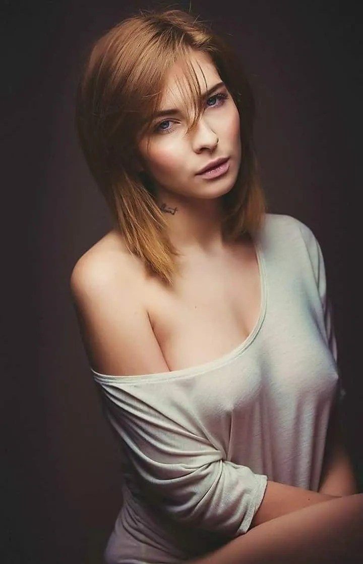 Young woman sitting with one side half shoulder white top