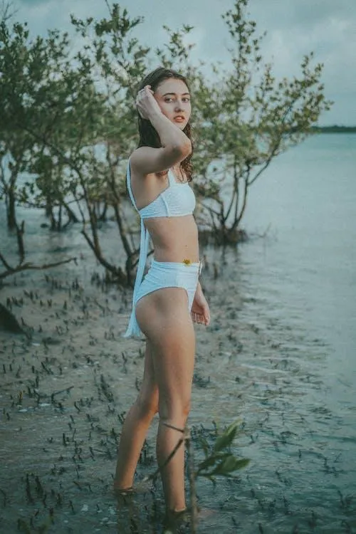 Young woman standing on the water wearing a white outfit