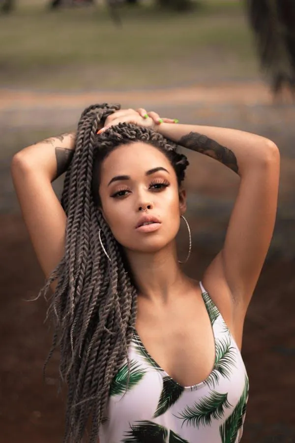 Young woman with a floral top and braid hairstyle wallpaper