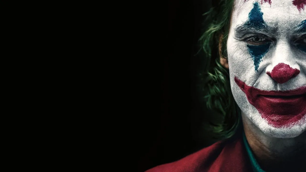 Close Up of Joker with Dark Red Glow and Serious Look HD Wallpaper