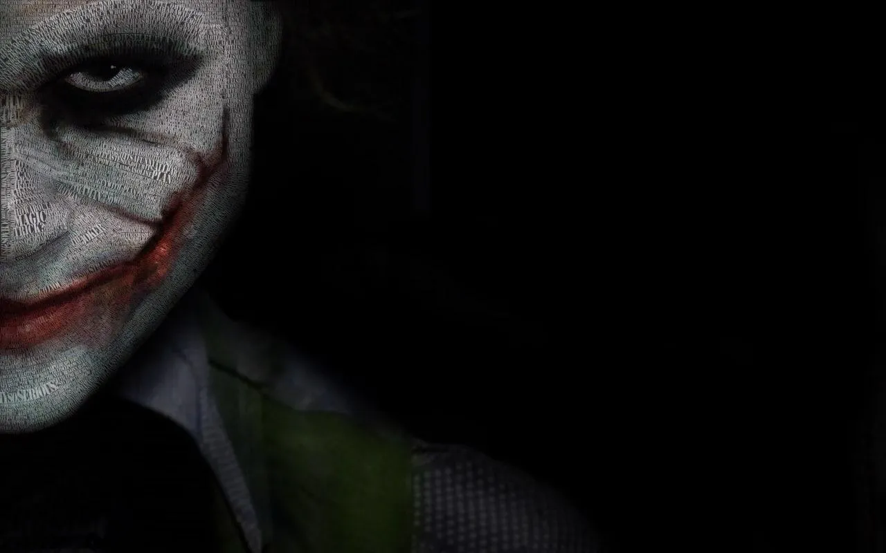 Half Face of Joker Hidden in Deep Dark City Shadows Wallpaper