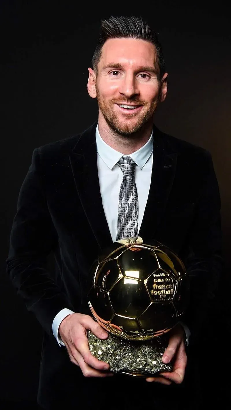 The Goat Messi In Black Dress With Football Trophy Wallpaper