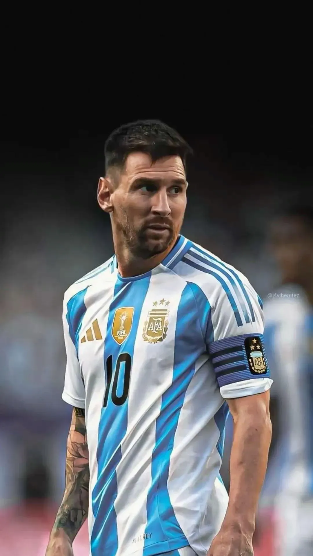 Lionel Messi In An Argentina Jersey Looking Behind Wallpaper