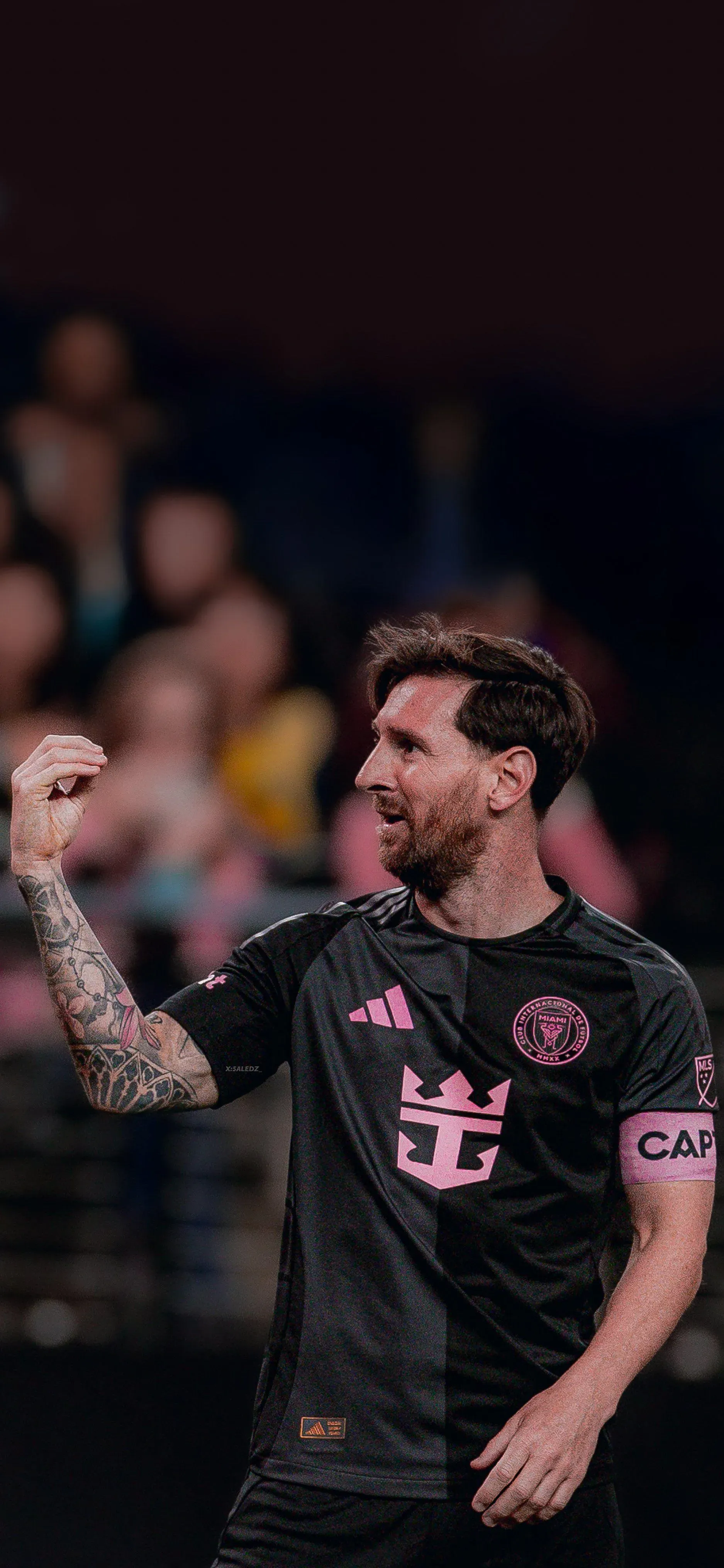 Lionel Messi In A Black Jersey Looking His Fans HD Wallpaper