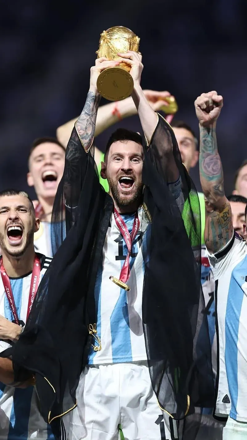 Lionel Messi is Celebrating With Football Cup Iconic Image