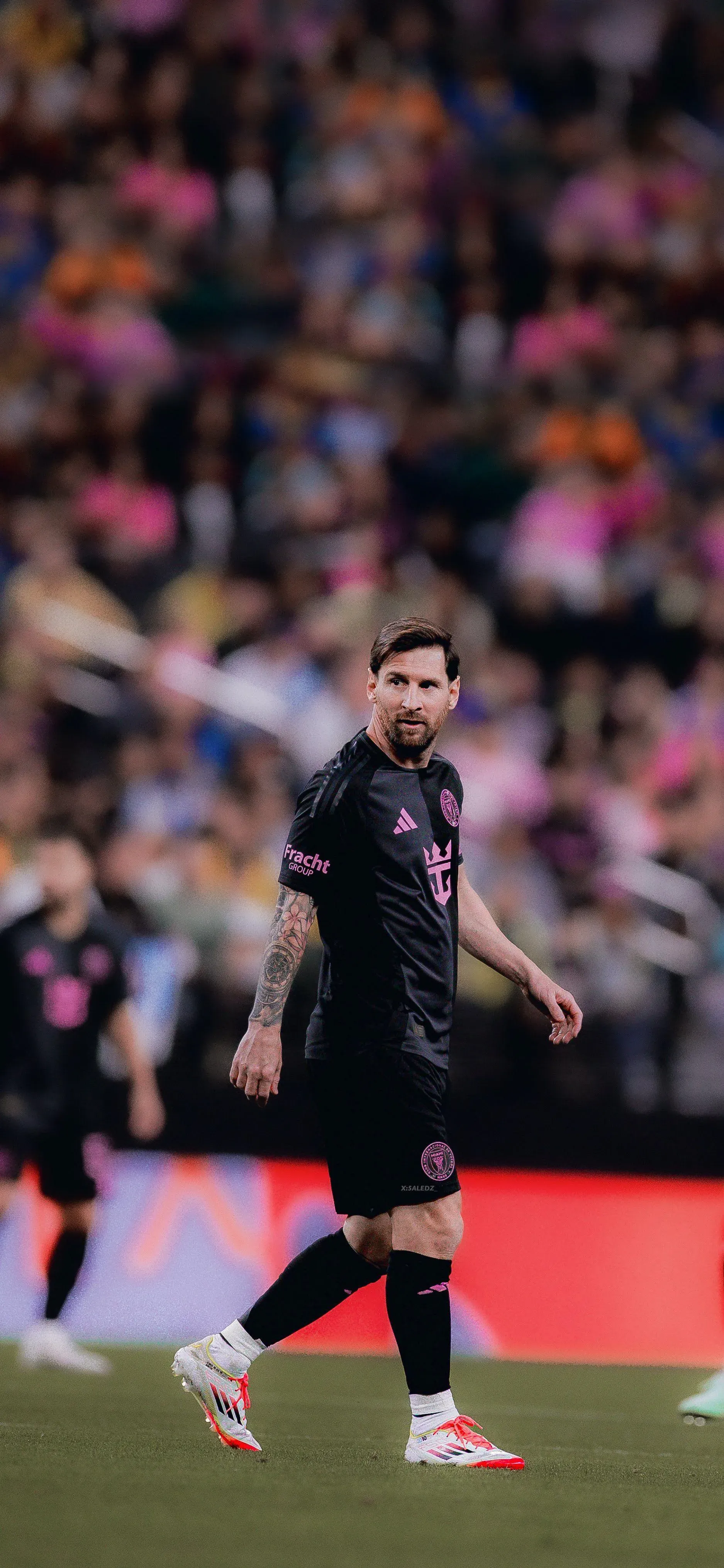 Messi In A Black Jersey on The Ground Free HD Wallpaper