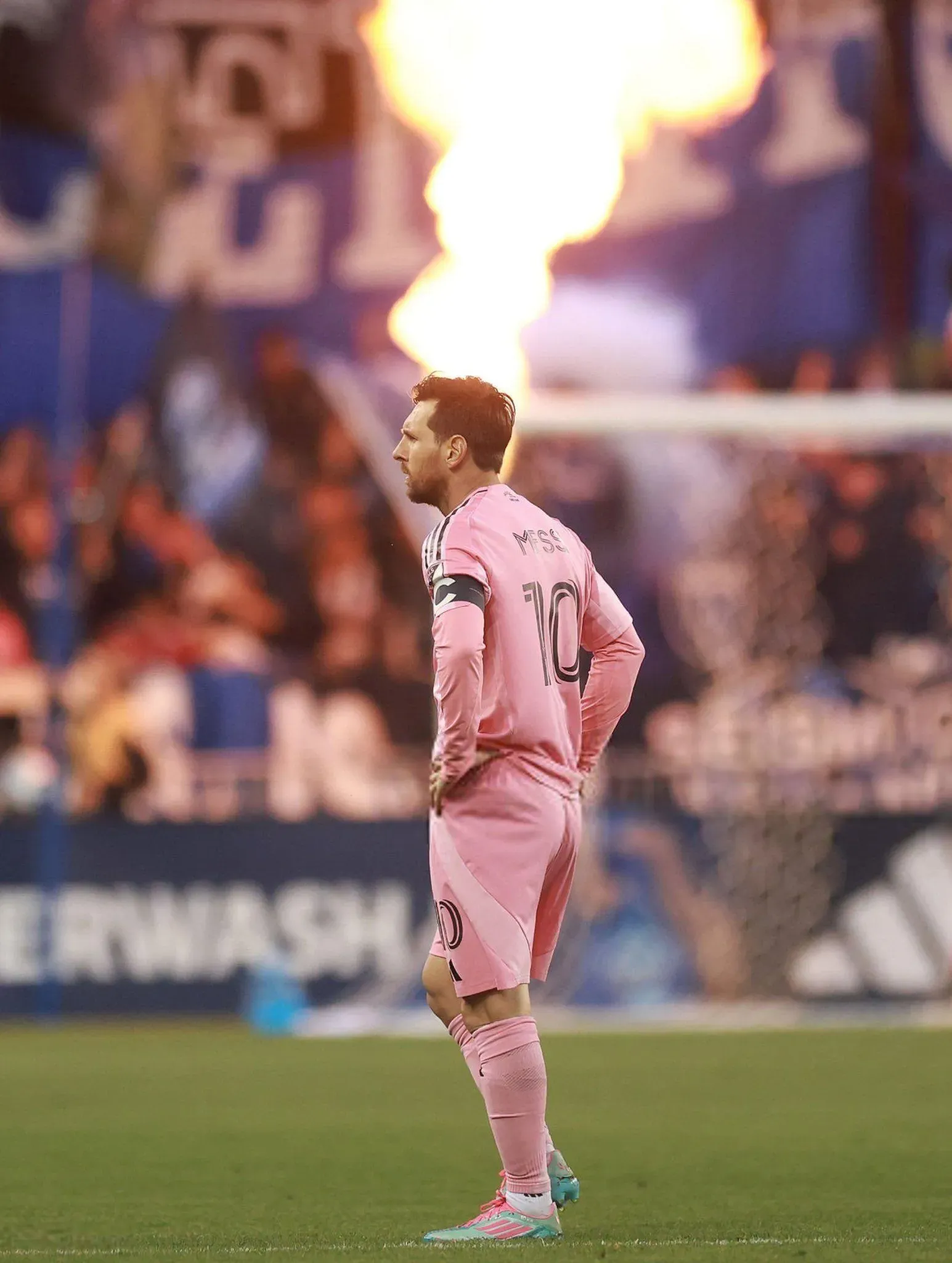 Messi Side Pose In Pink Jersey on The Ground Free Wallpaper