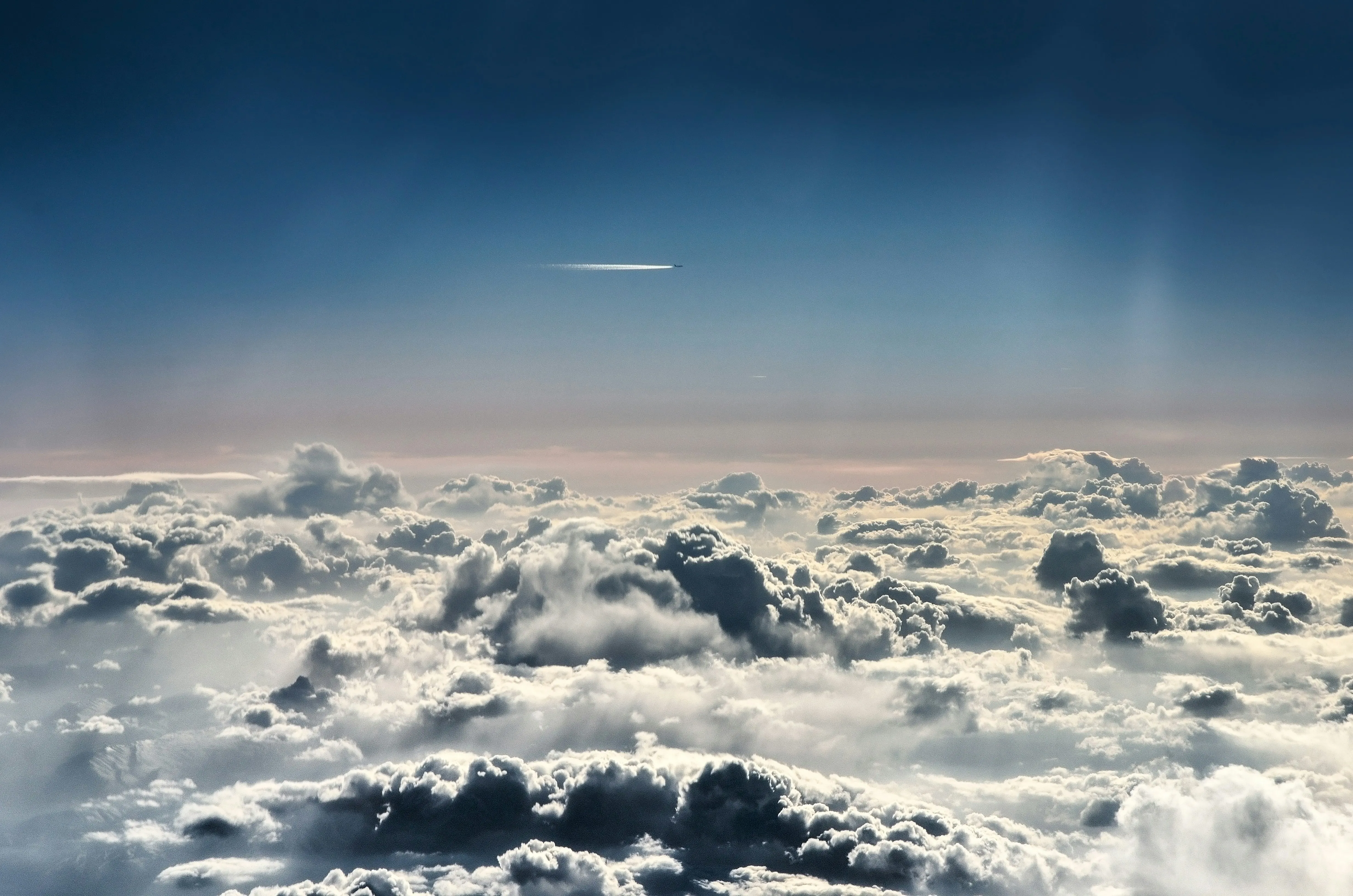Above the Clouds with Blue Sky and Jet Trail Image