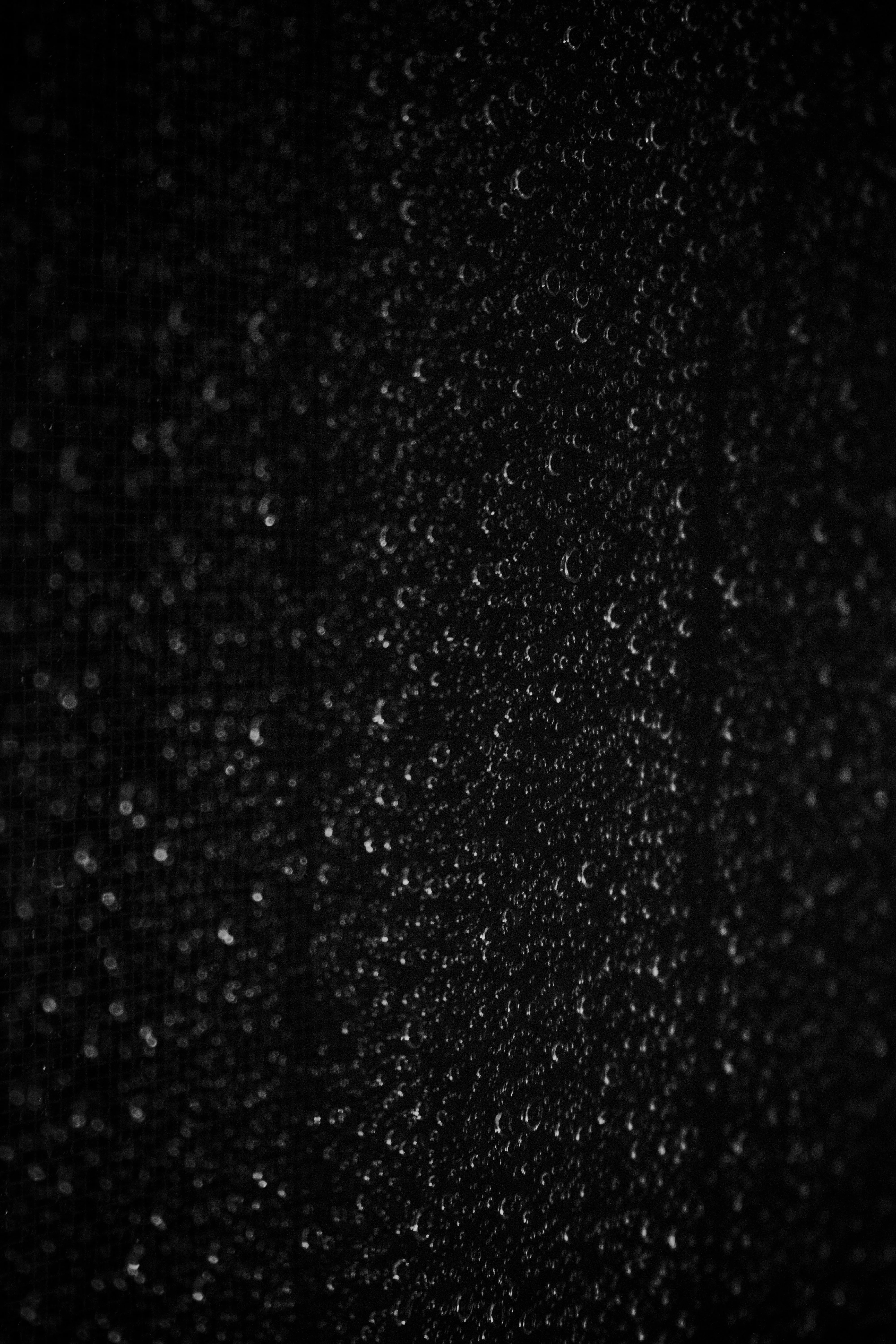 Abstract Vertical Rain Streaks on Black Night Backdrop