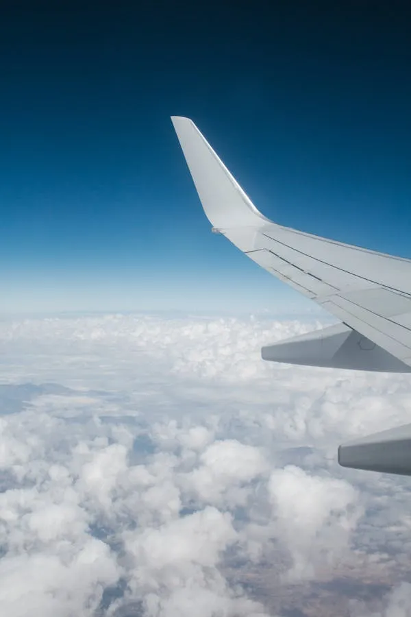 Aerial View of Clouds From Window of an Airplane Wallpaper