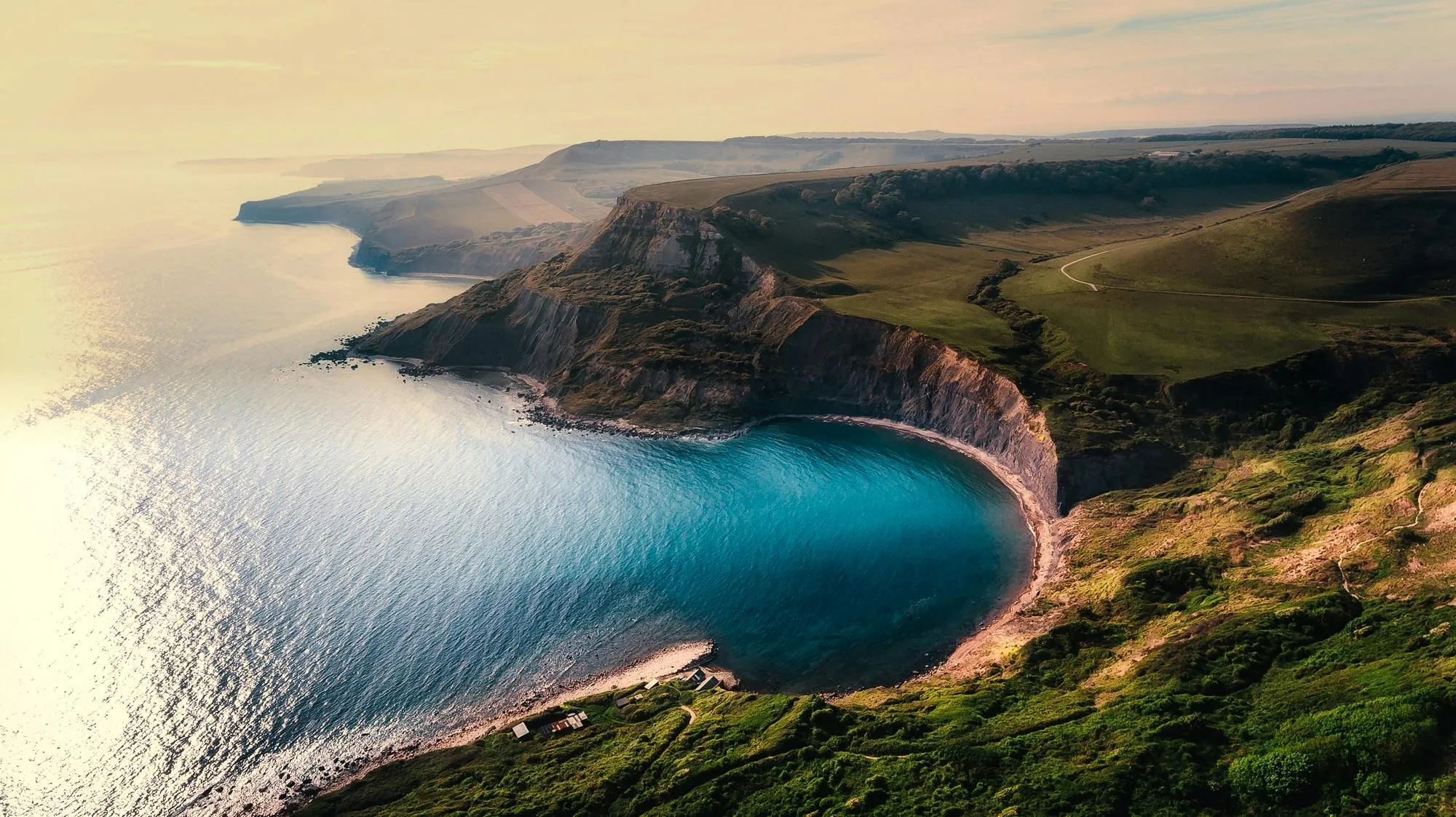 Aerial View of Coastline with Clouds and Turquoise Water