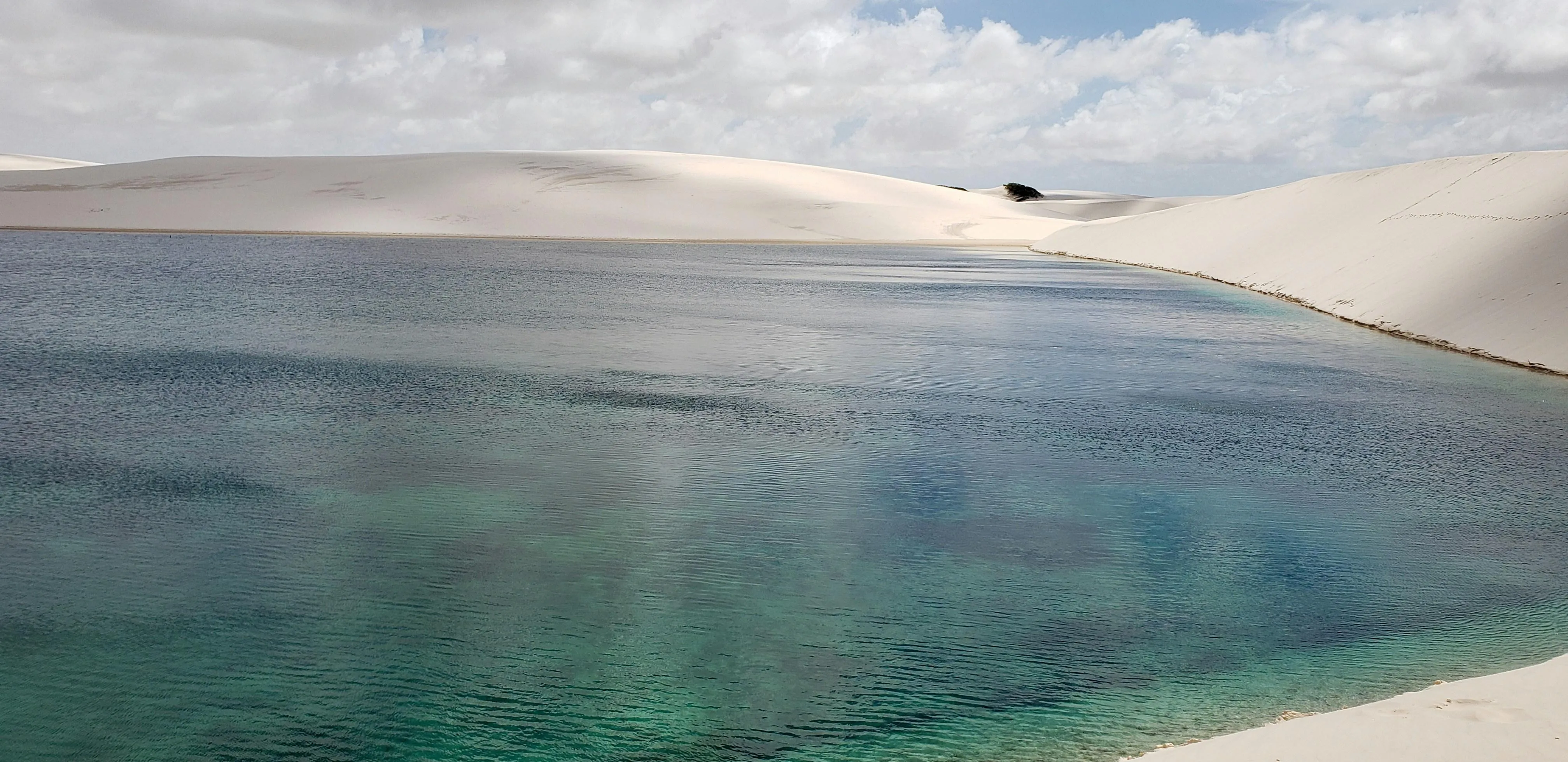 Aerial View of Peaceful Lake and Sandy Shoreline Wallpaper