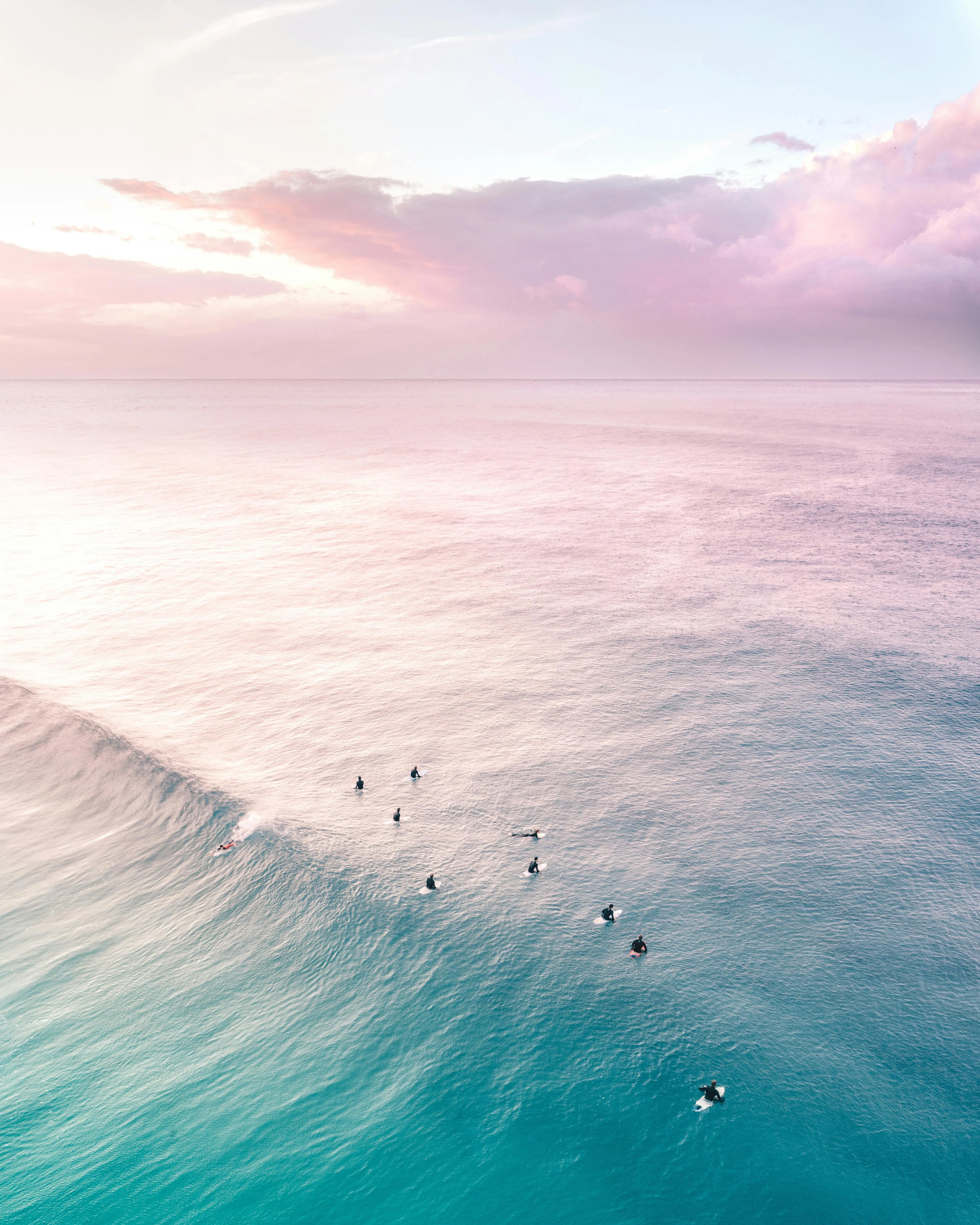 Aerial View of Pink Clouds Over Turquoise Ocean Wallpaper