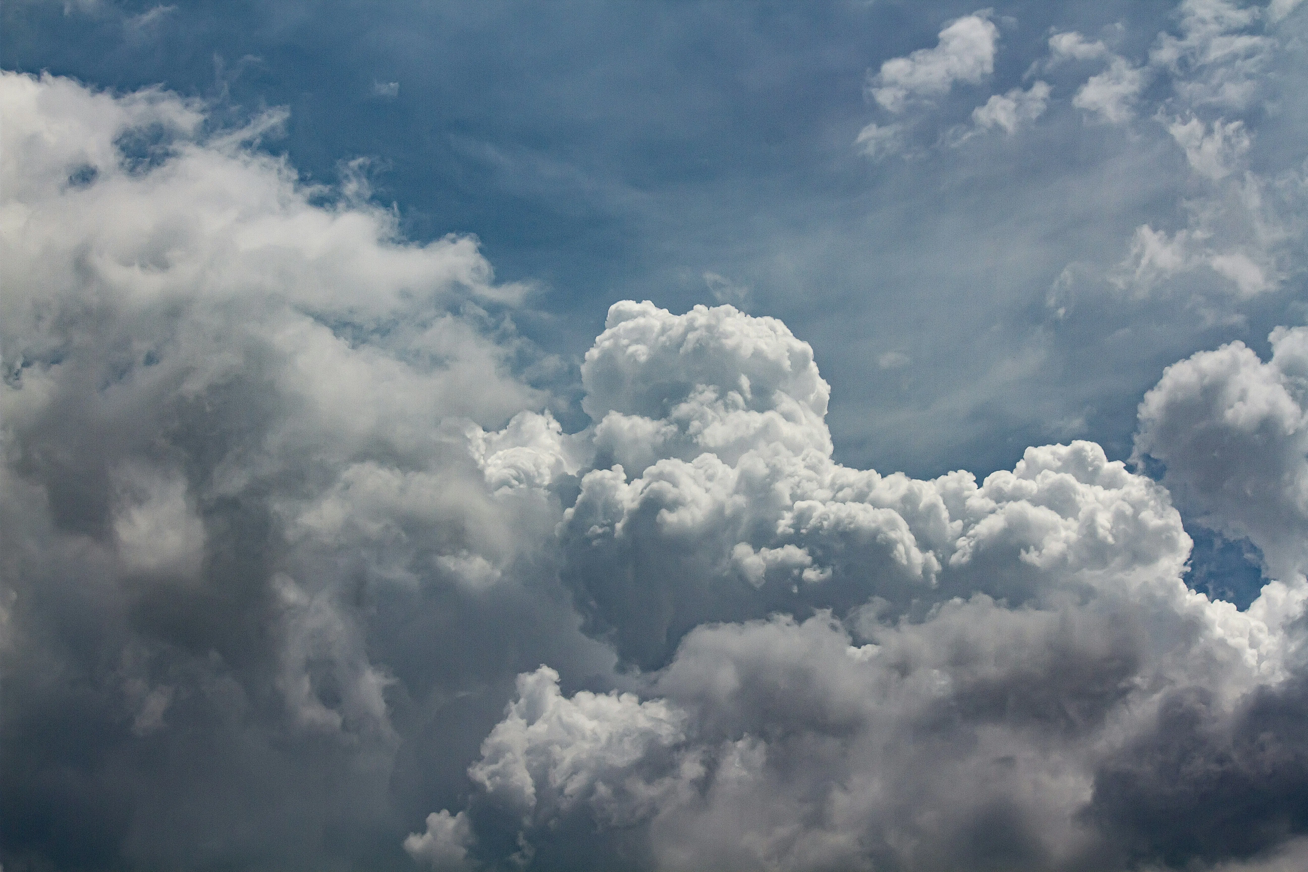 Aerial View of Puffy Clouds Over Clear Blue Landscape