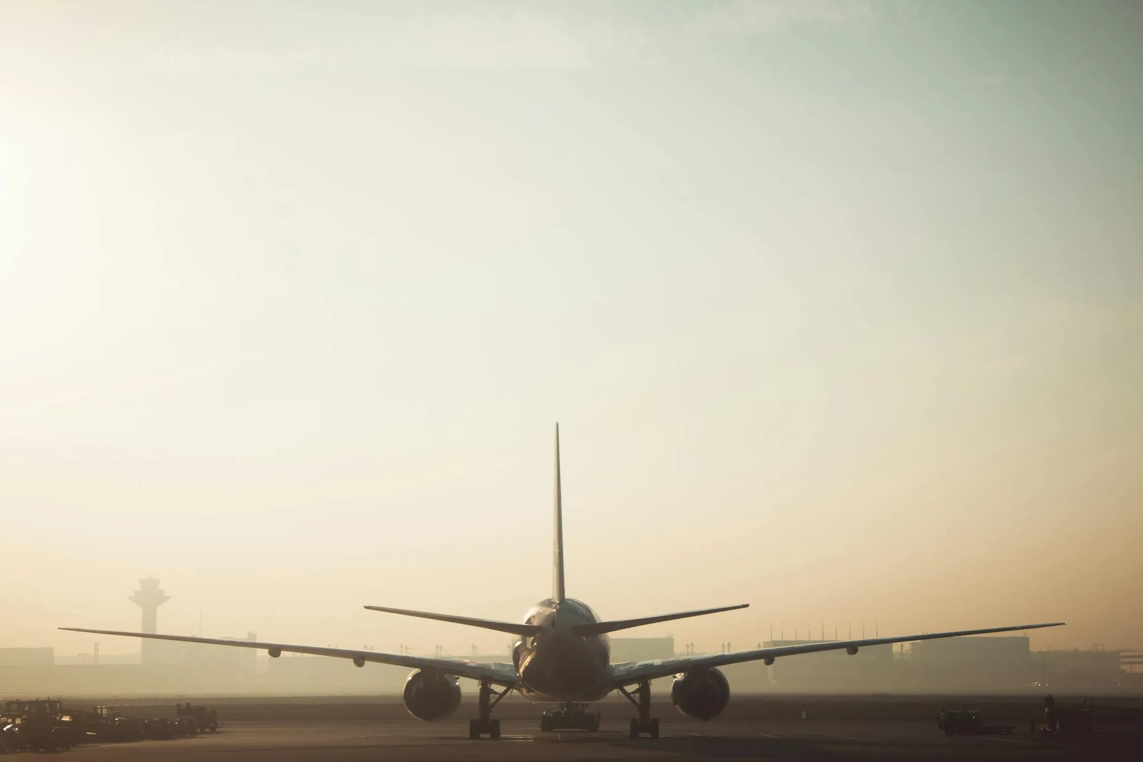 Airplane Taxiing Under a Calm Cloudy Sky at Sunset