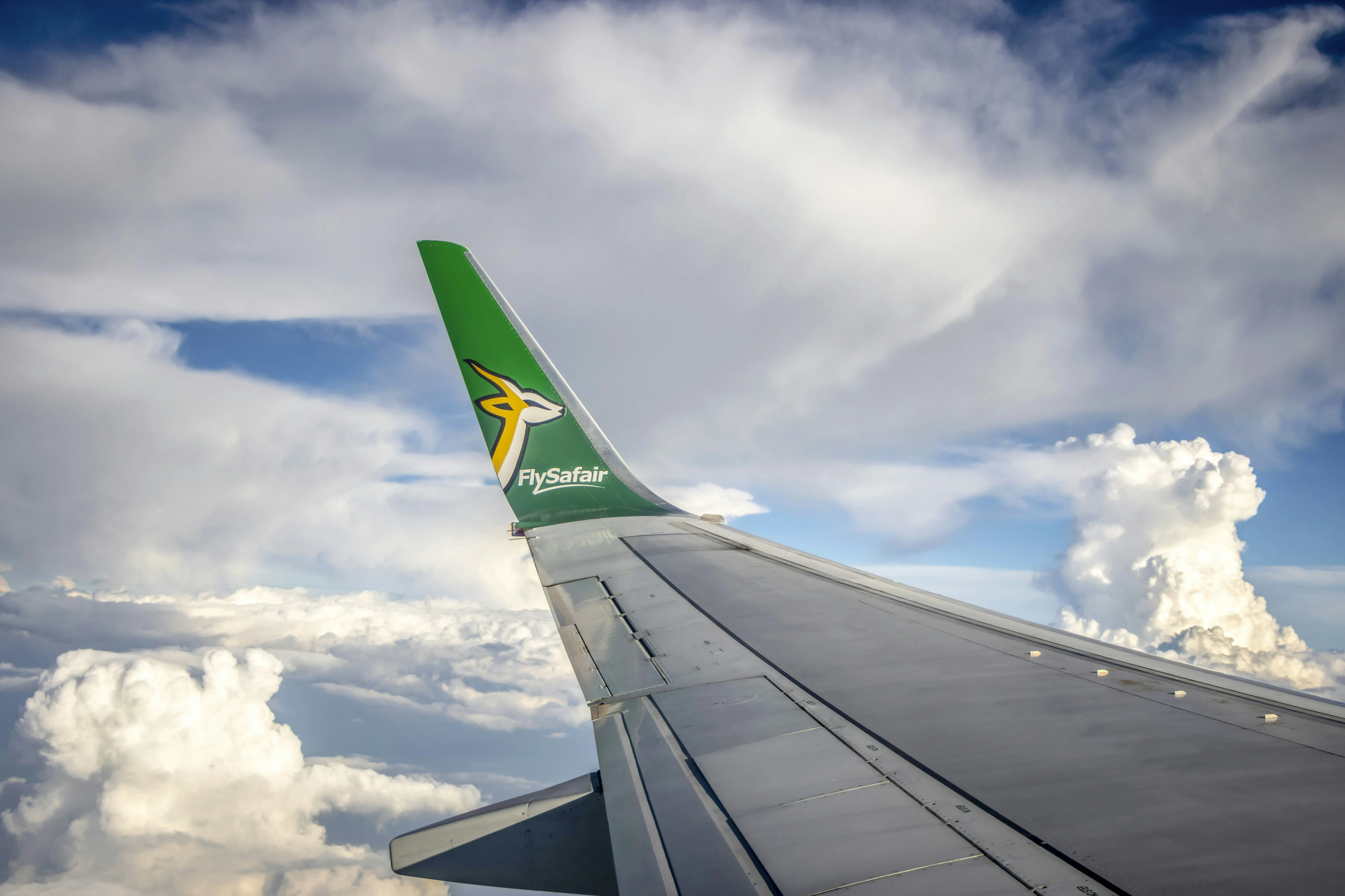 Airplane Wing Flying Above White Fluffy Clouds Wallpaper