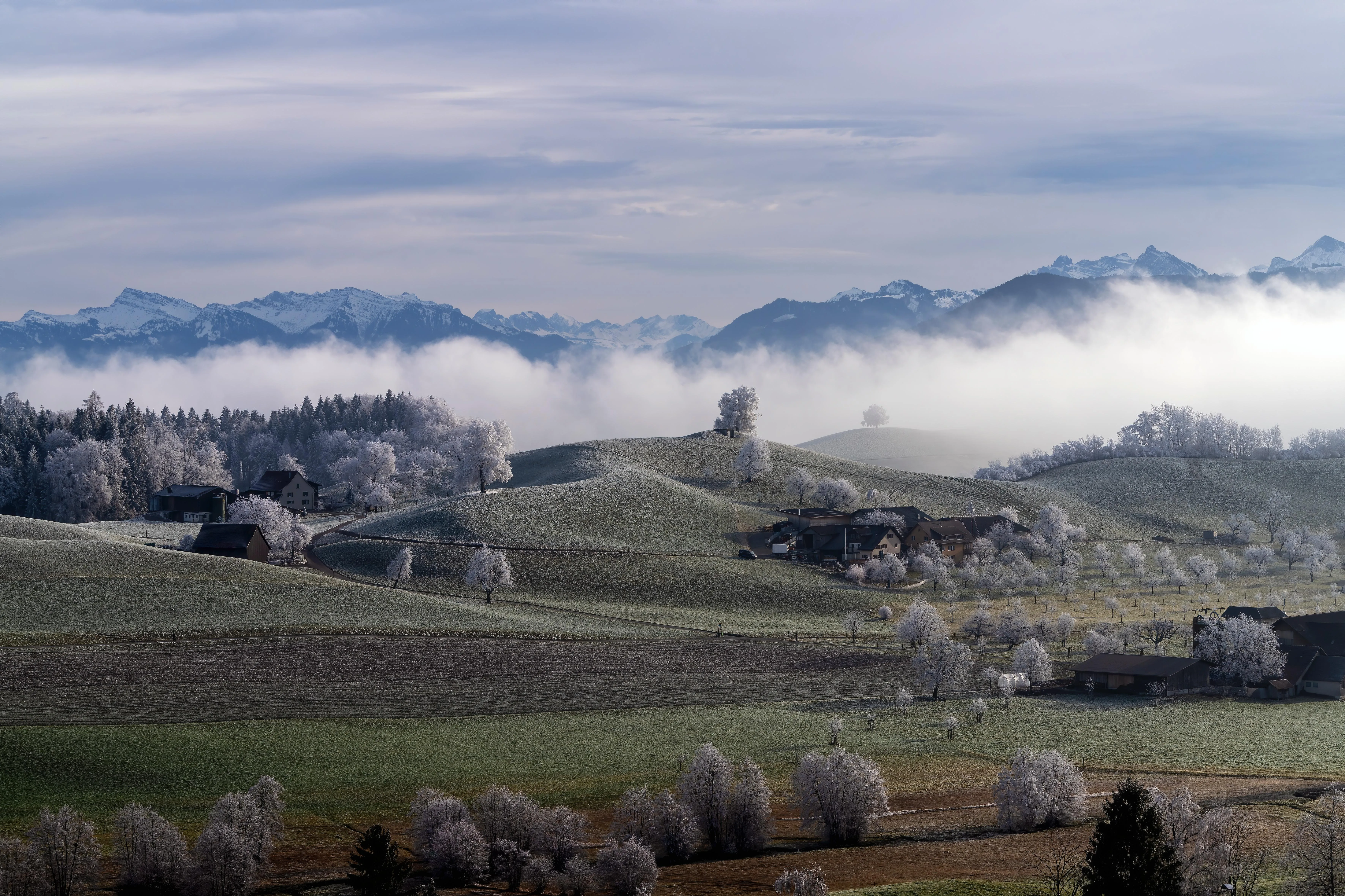 Alpine village beneath snow covered peaks HD image