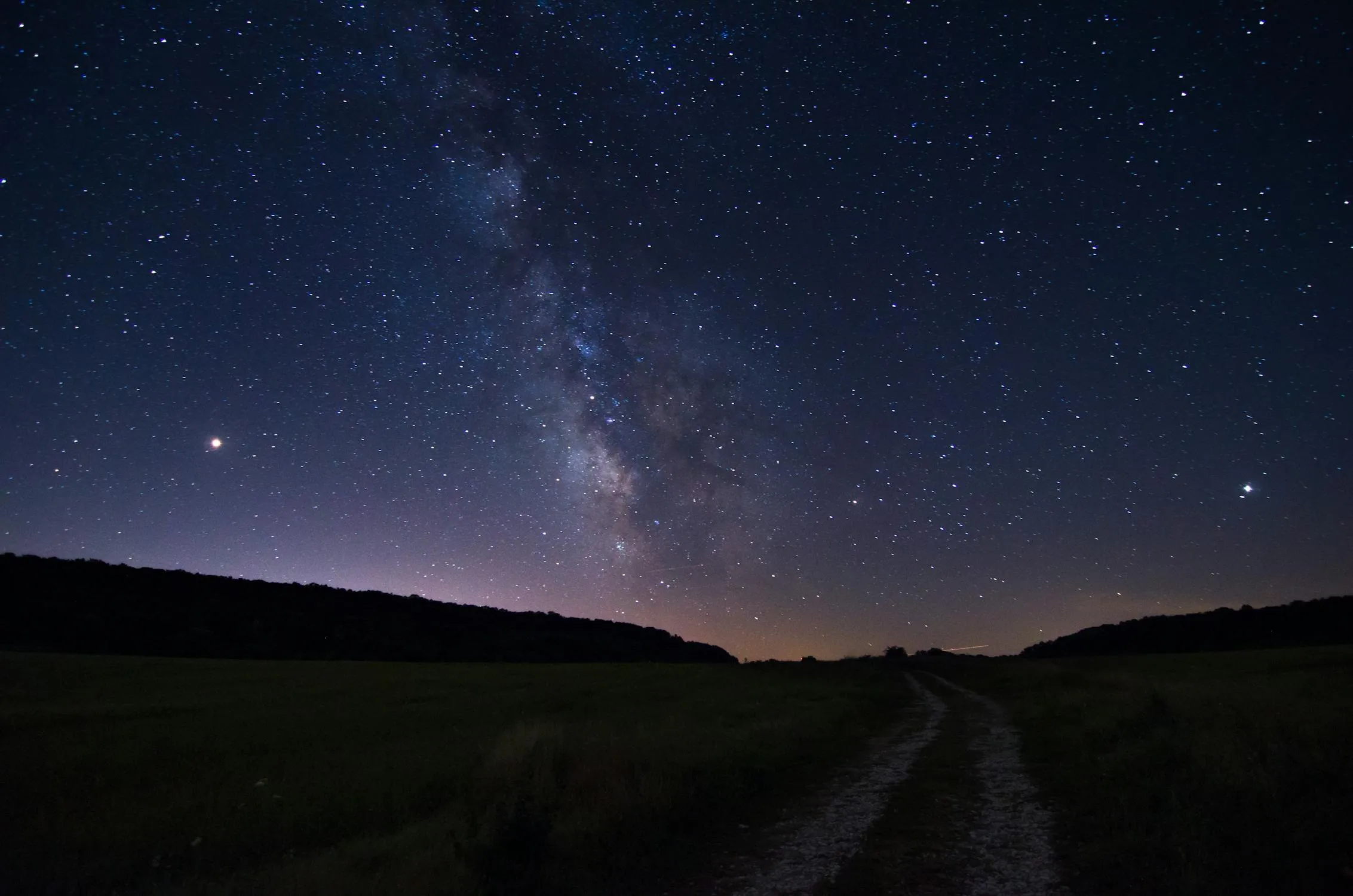 Amazing Starry Night Sky Over Dark Rolling Hills Image