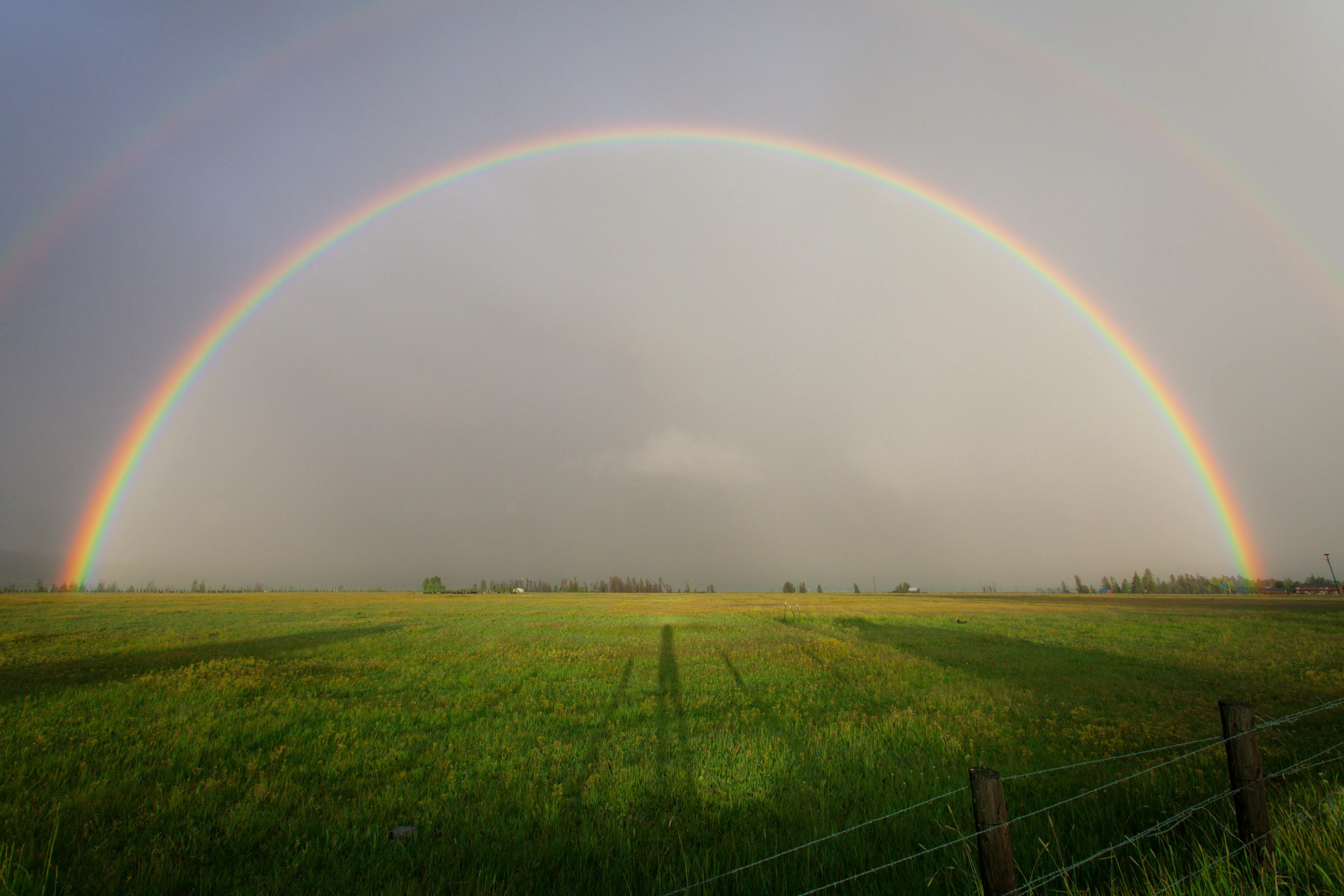 Beautiful Double Rainbow Arching Over Vast Green Farmland
