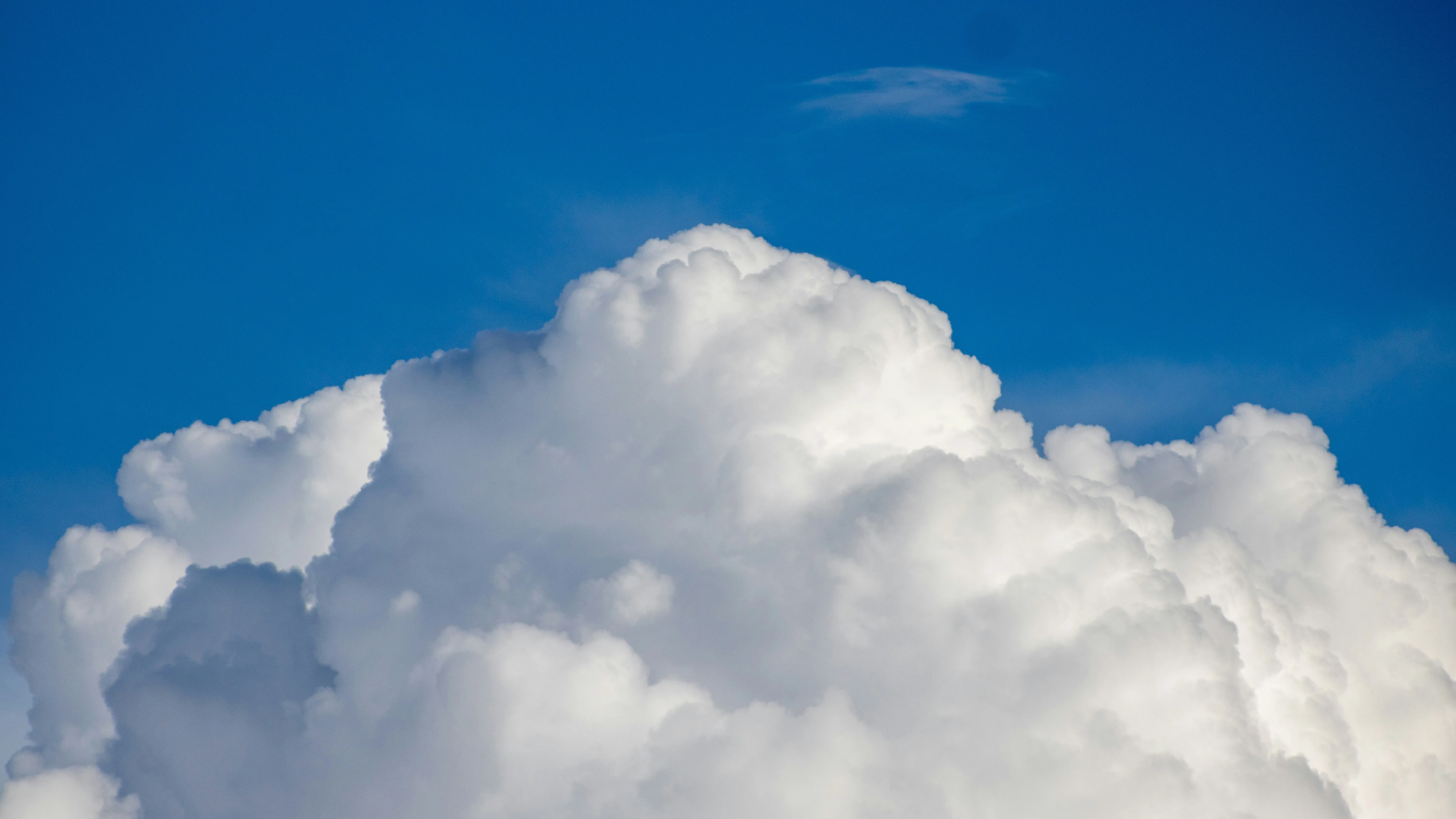 Big Fluffy White Clouds Against Deep Blue Sky on Sunny Day