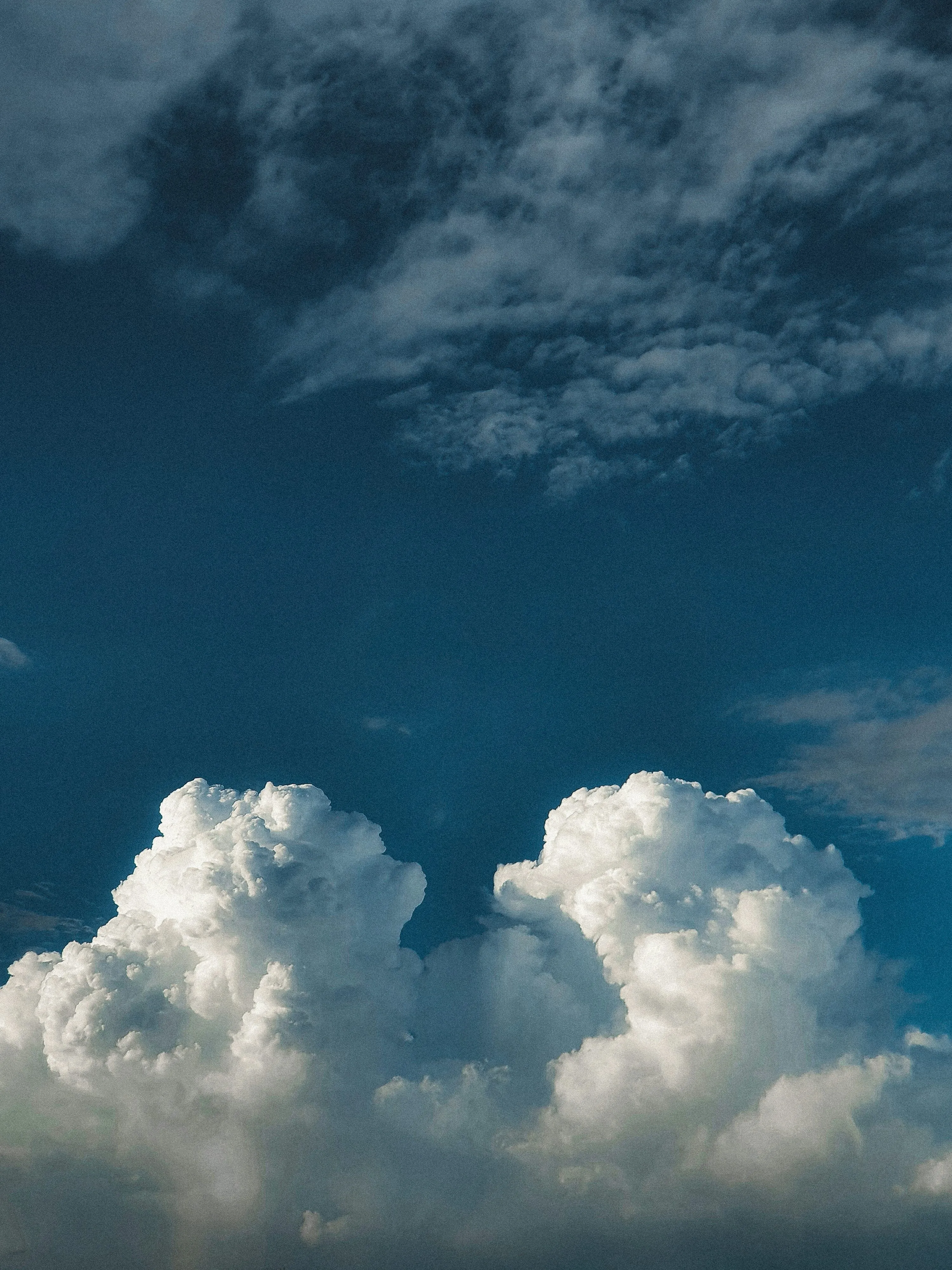 Billowing White Clouds Forming in a Deep Blue Sky Image