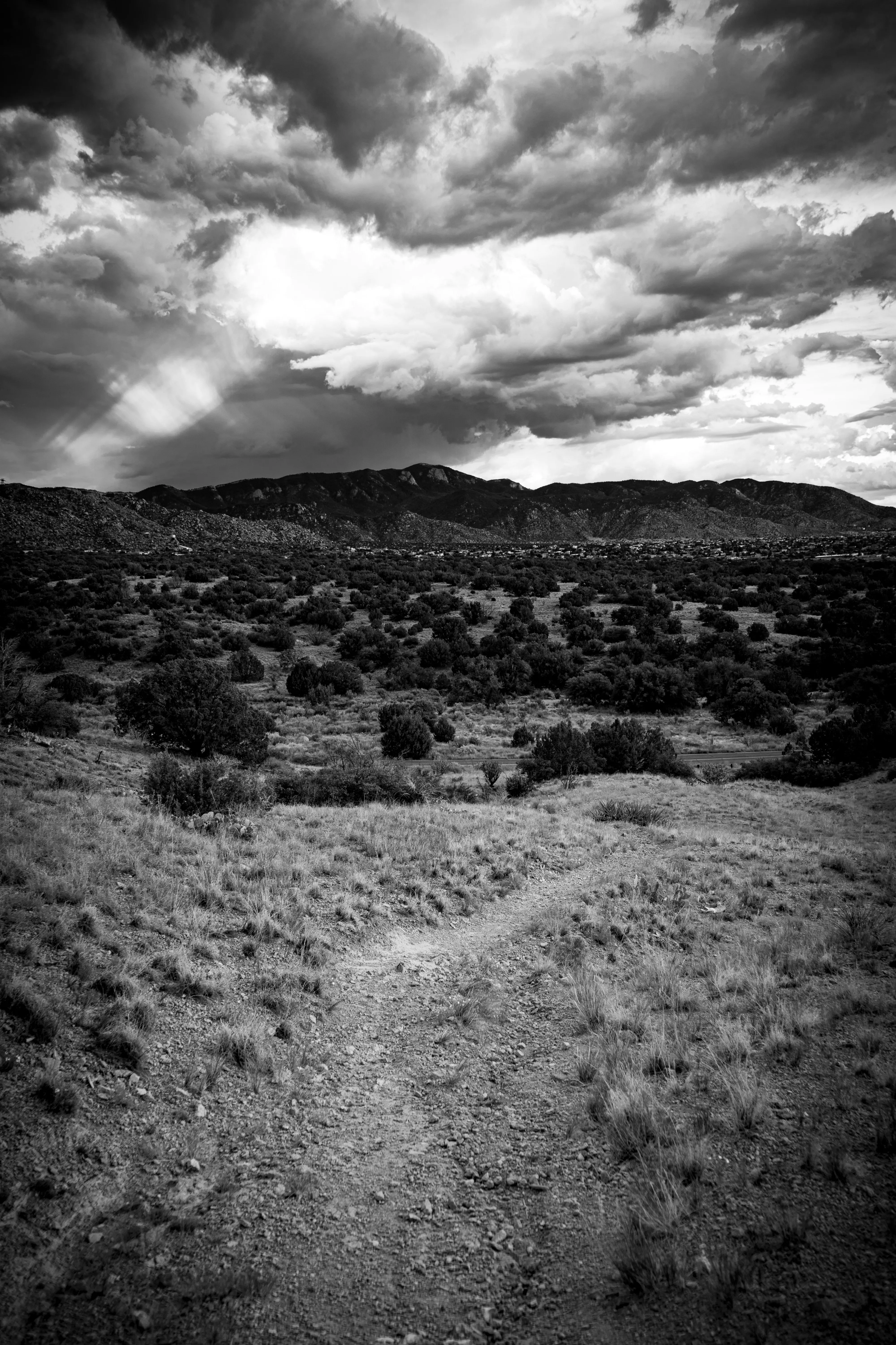 Black and White Image of Rocky Terrain and Sky Wallpaper