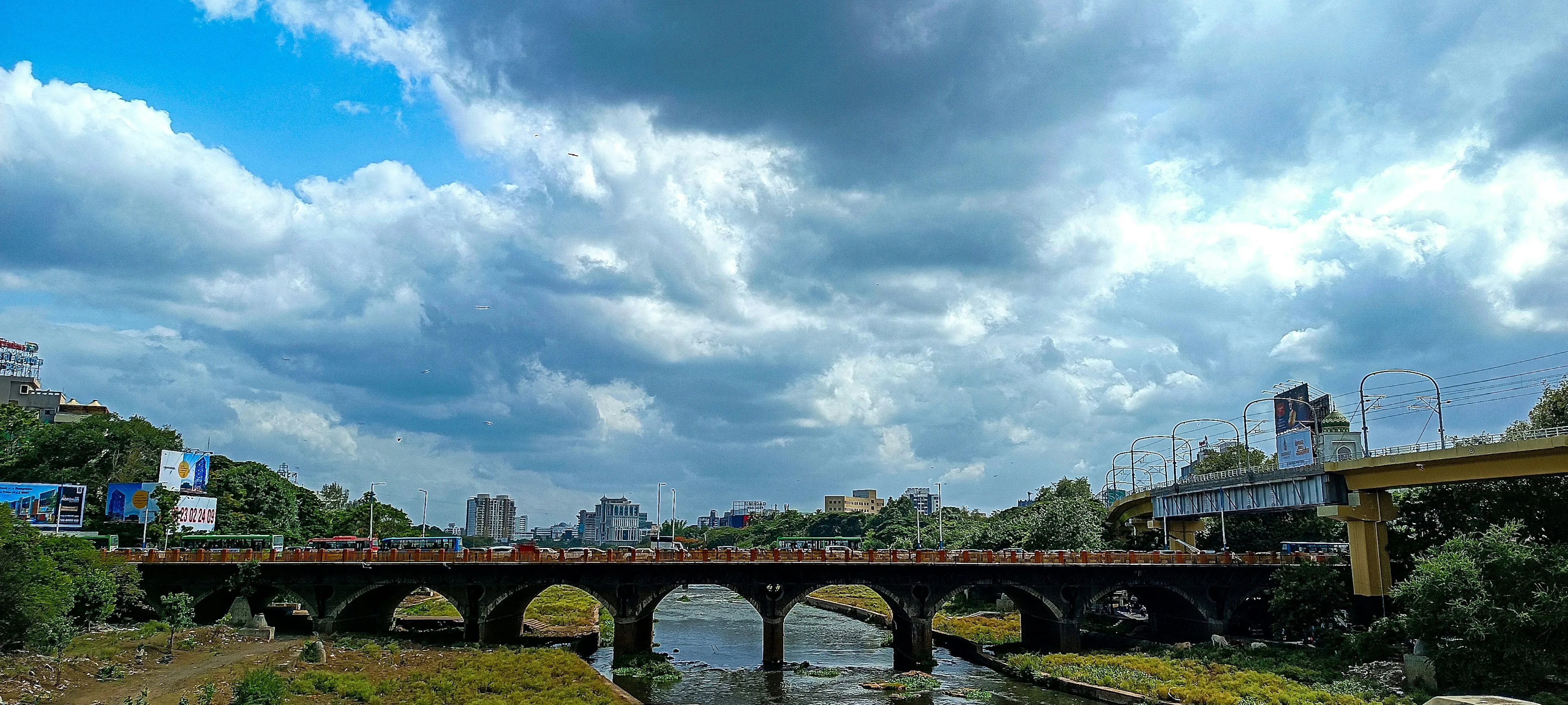 Blue Sky and Puffy Clouds Over a Historic Stone Bridge