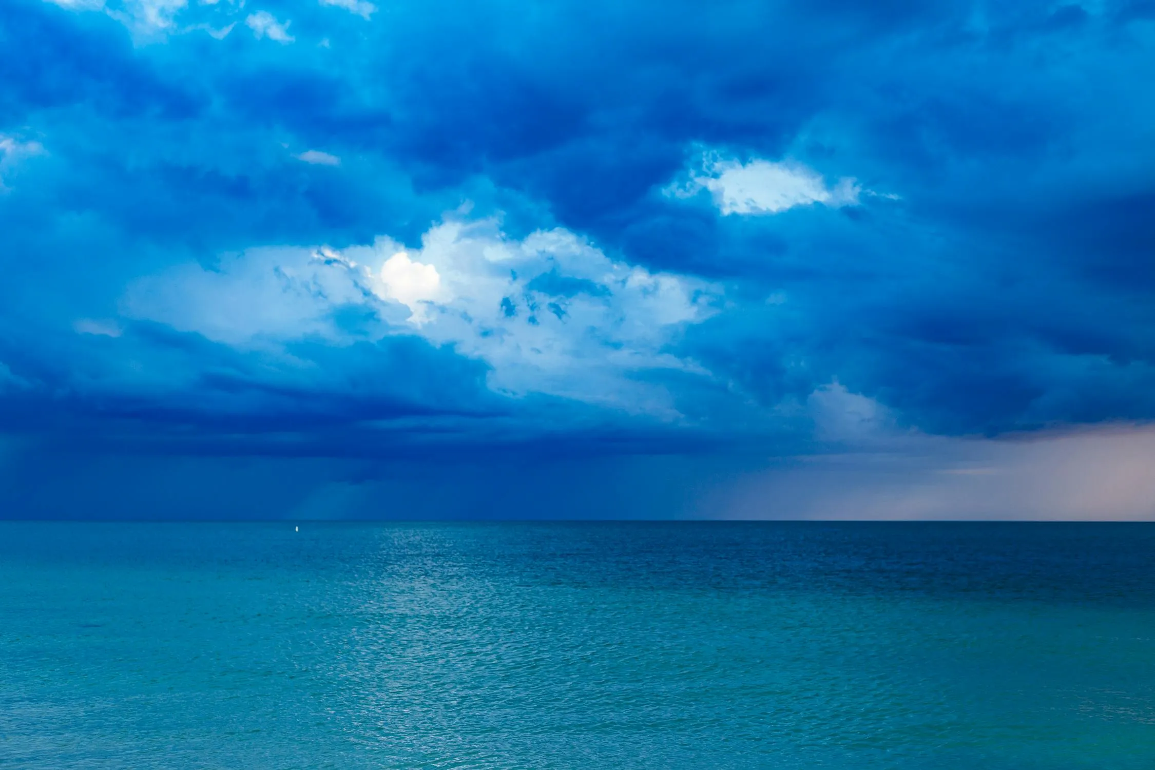 Blue Sky and Turquoise Ocean with Bright White Clouds