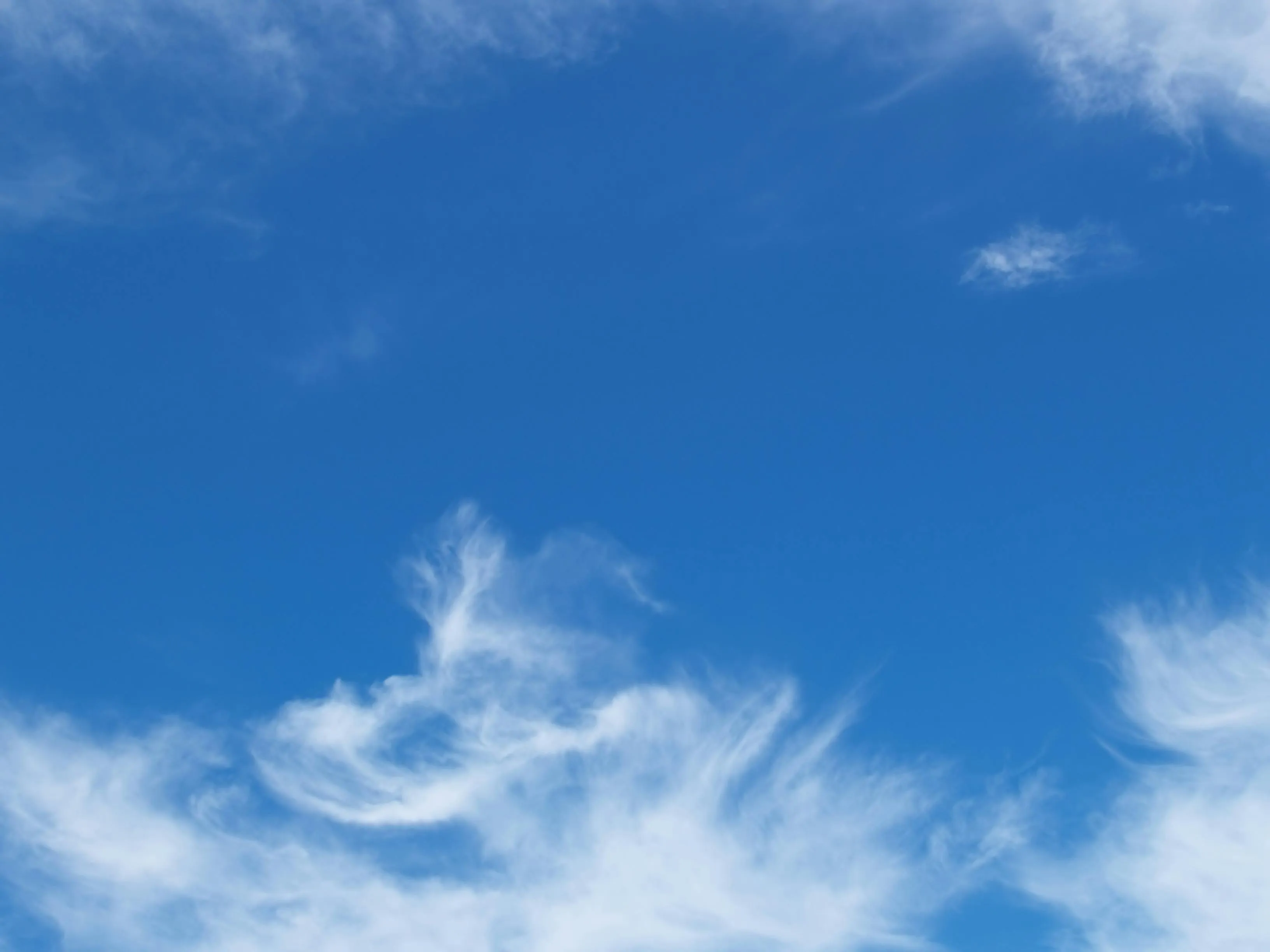 Blue Sky with Delicate White Clouds Floating Lightly Image
