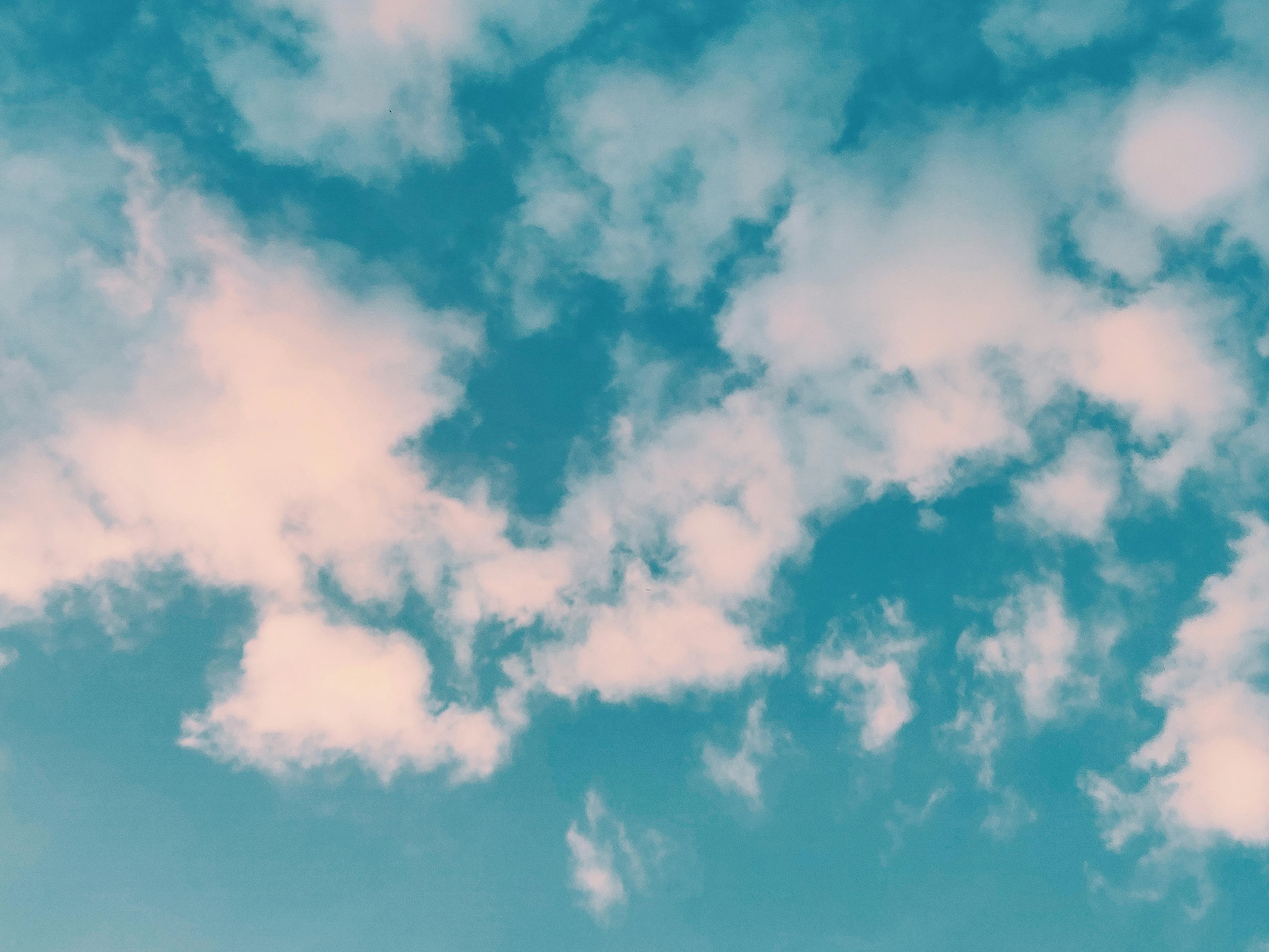 Blue Sky with Scattered Fluffy Clouds and Sunlight Image