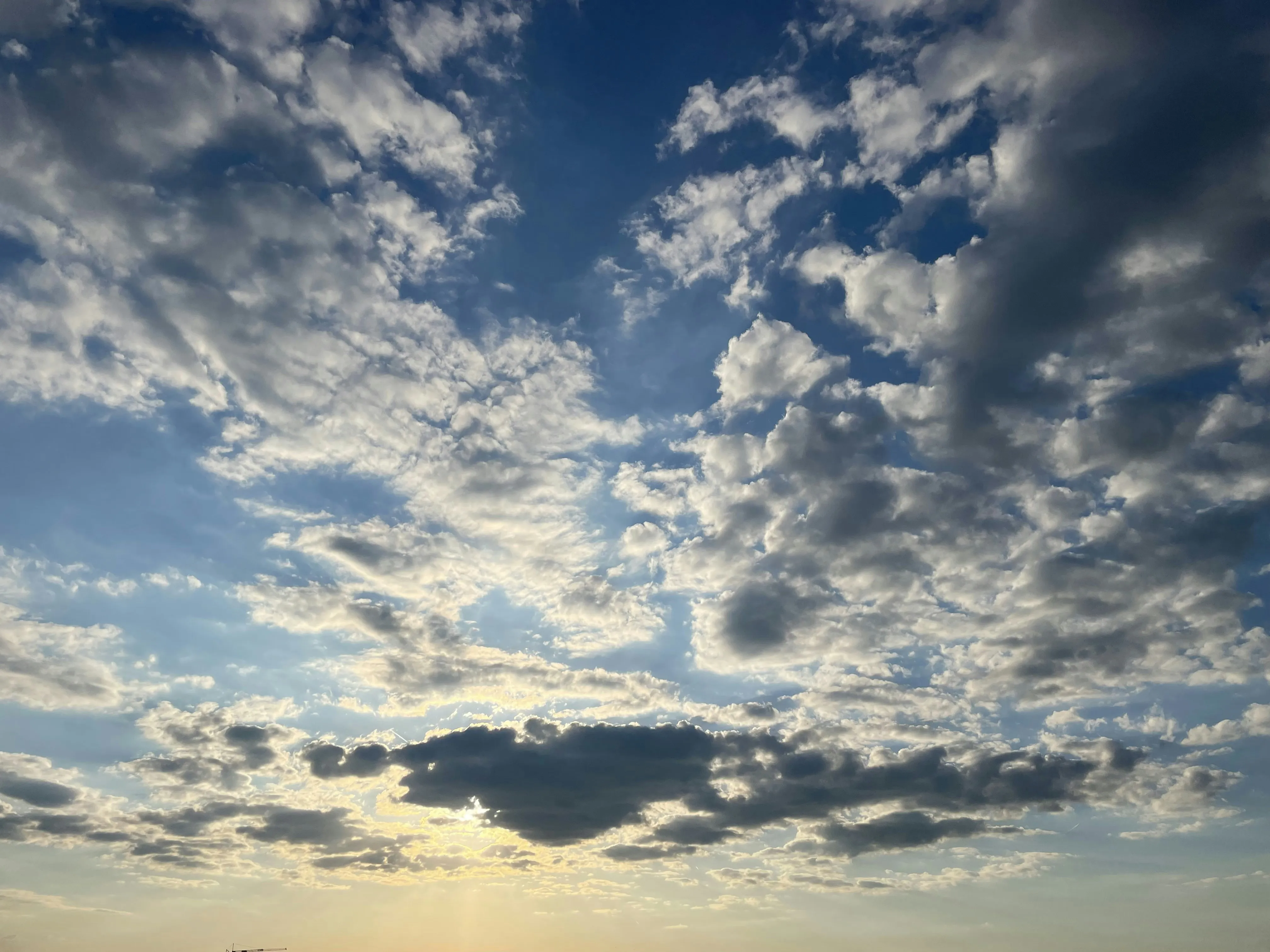 Blue Sky with Scattered Puffy White Clouds and Sunshine