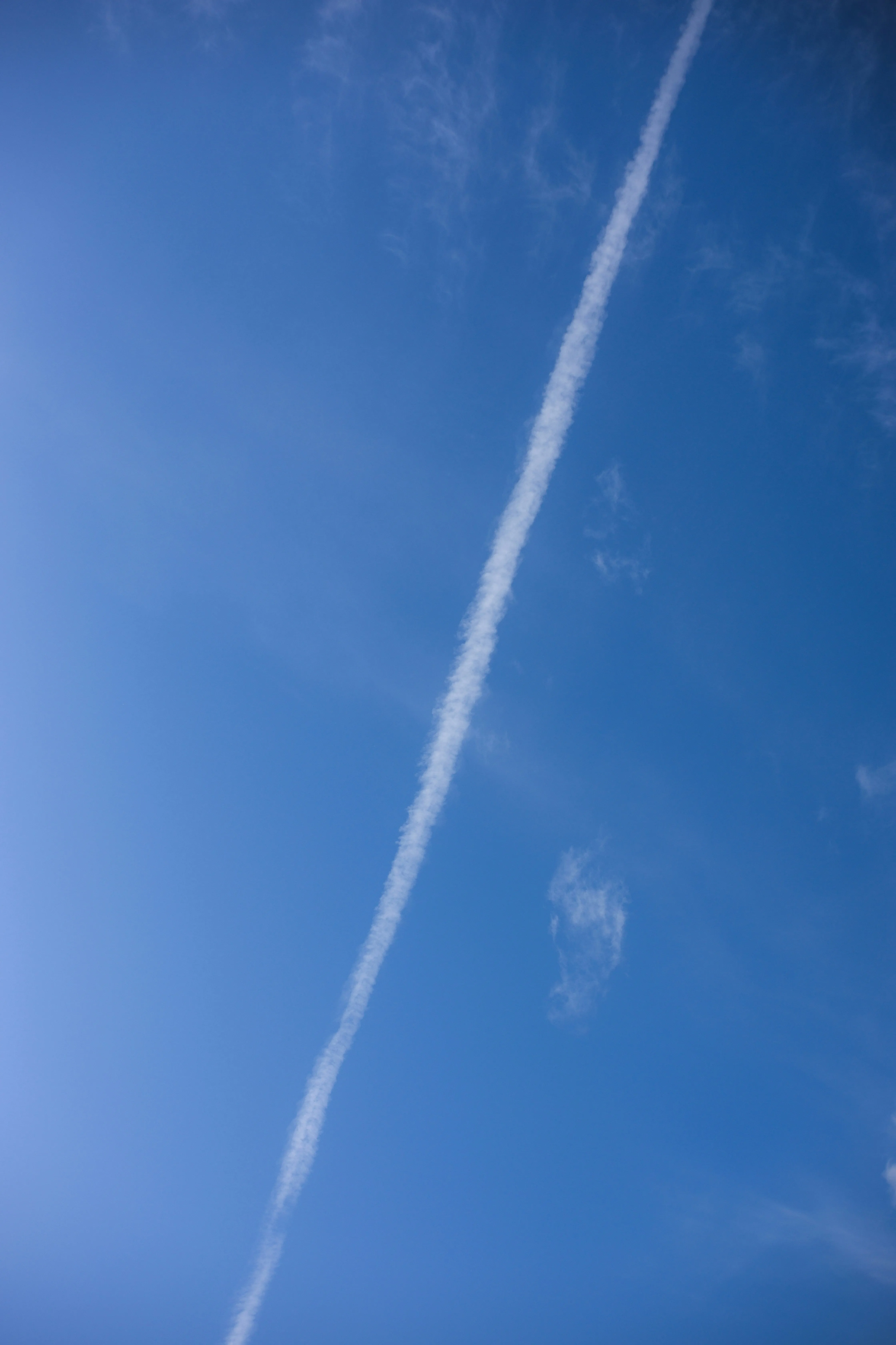 Blue Sky with Single Contrail Line Stretching Across It