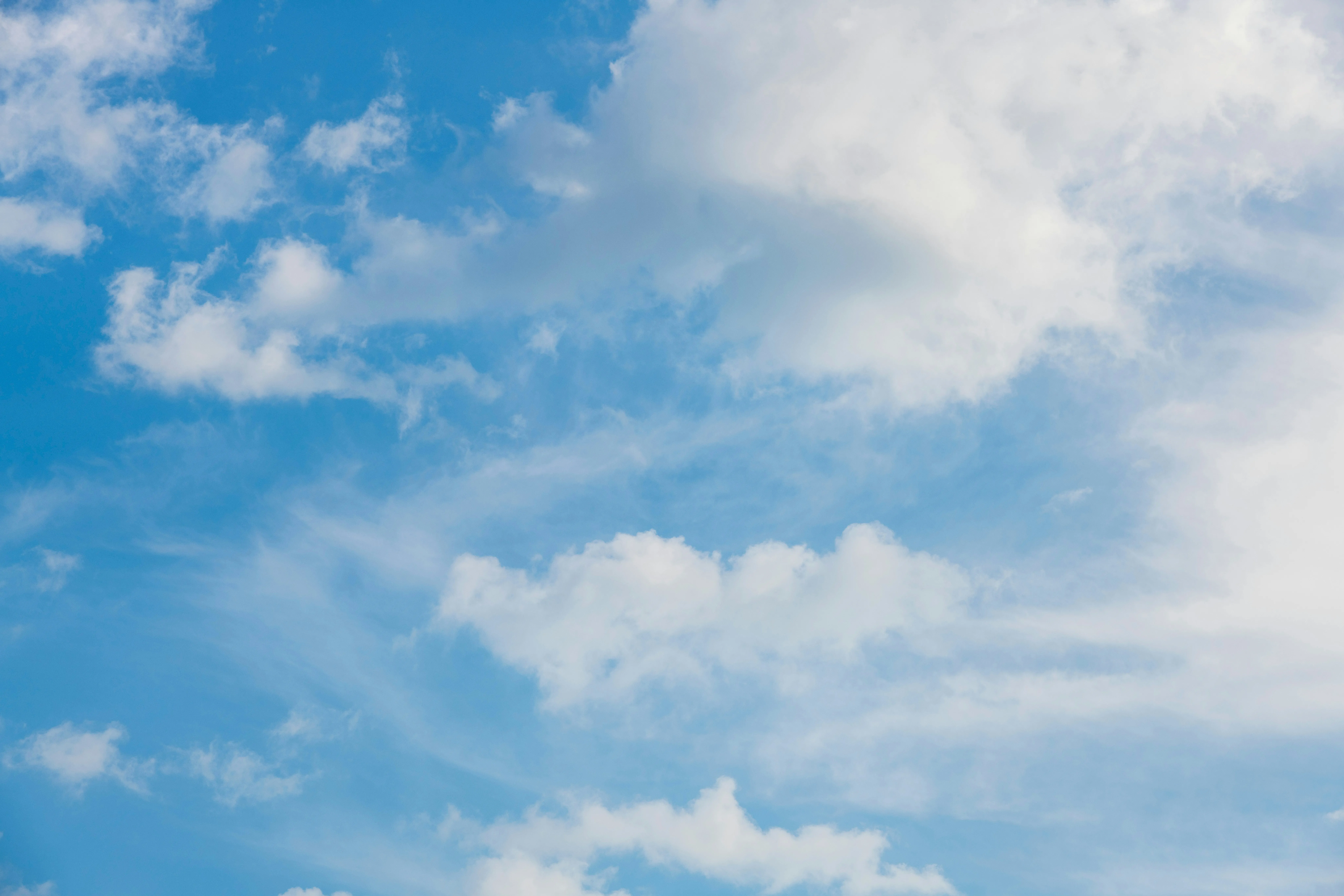 Blue Sky with White Clouds Over Open Field View Wallpaper